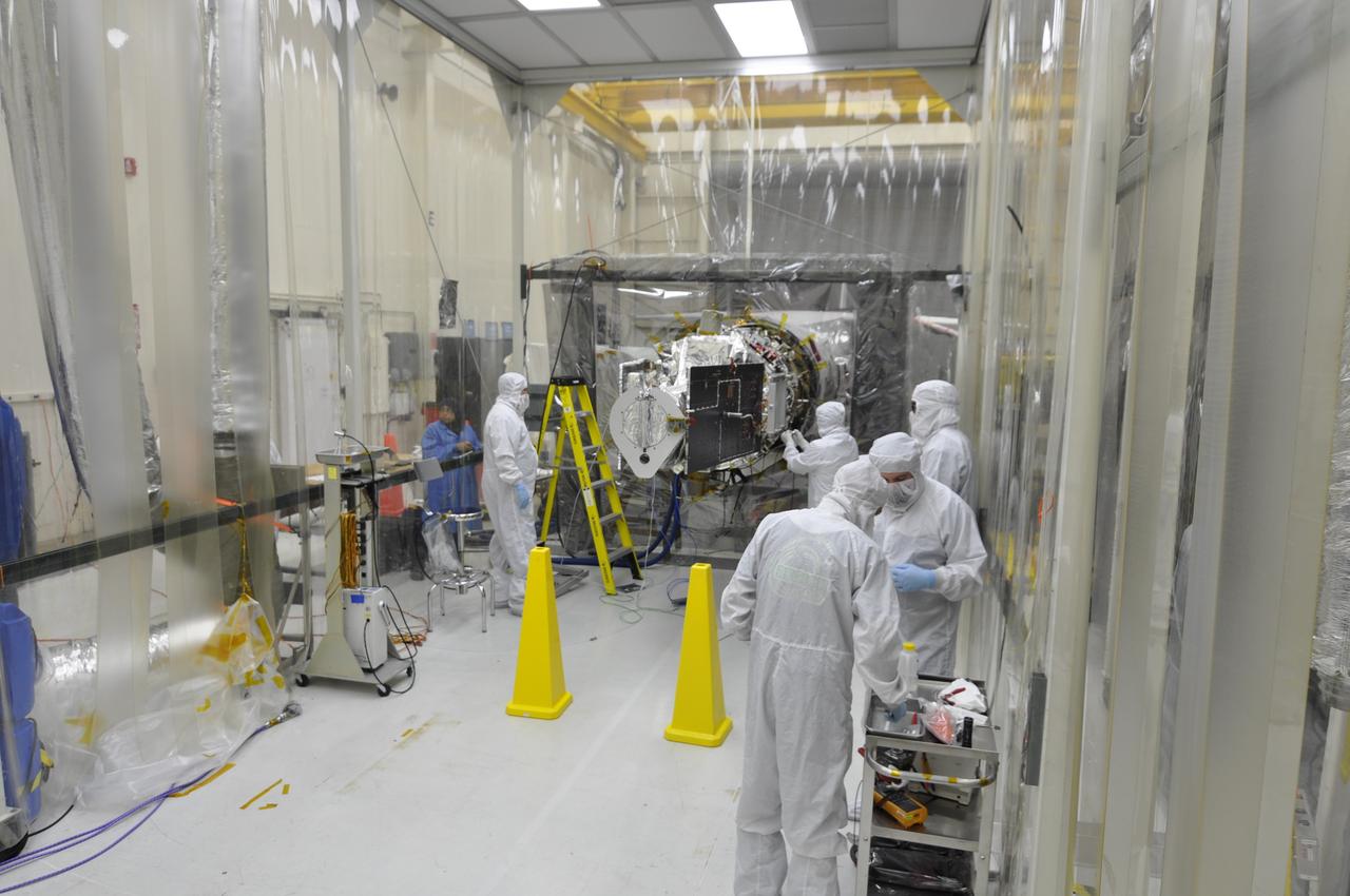 VANDENBERG AFB, Calif. – Engineers unwrap NASA's IRIS spacecraft after its connection to the nose of an Orbital Sciences Pegasus XL rocket that will lift the solar observatory into orbit in June. The work is taking place in a hangar at Vandenberg Air Force Base where IRIS, short for Interface Region Imaging Spectrograph, is being prepared for launch on a Pegasus XL rocket. Scheduled for launch from Vandenberg June 26, IRIS will open a new window of discovery by tracing the flow of energy and plasma through the chromospheres and transition region into the sun’s corona using spectrometry and imaging. IRIS fills a crucial gap in our ability to advance studies of the sun-to-Earth connection by tracing the flow of energy and plasma through the foundation of the corona and the region around the sun known as the heliosphere. Photo credit: NASA/Randy Beaudoin