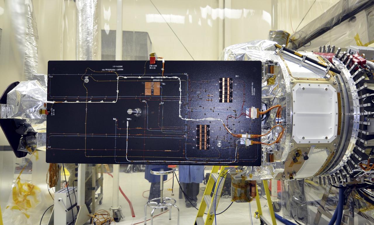 VANDENBERG AFB, Calif. – Engineers unwrap NASA's IRIS spacecraft after its connection to the nose of an Orbital Sciences Pegasus XL rocket that will lift the solar observatory into orbit in June. The work is taking place in a hangar at Vandenberg Air Force Base where IRIS, short for Interface Region Imaging Spectrograph, is being prepared for launch on a Pegasus XL rocket. Scheduled for launch from Vandenberg June 26, IRIS will open a new window of discovery by tracing the flow of energy and plasma through the chromospheres and transition region into the sun’s corona using spectrometry and imaging. IRIS fills a crucial gap in our ability to advance studies of the sun-to-Earth connection by tracing the flow of energy and plasma through the foundation of the corona and the region around the sun known as the heliosphere. Photo credit: NASA/Randy Beaudoin