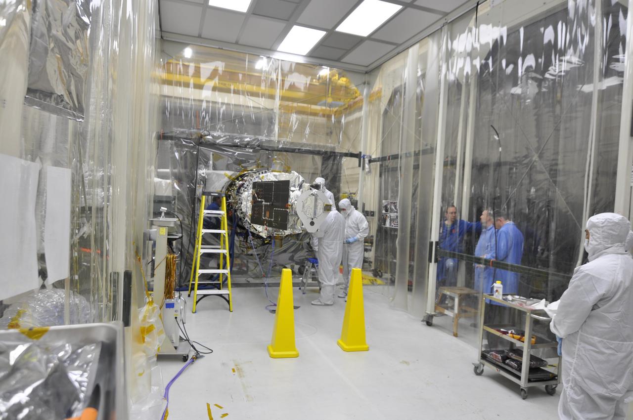 VANDENBERG AFB, Calif. – Engineers unwrap NASA's IRIS spacecraft after its connection to the nose of an Orbital Sciences Pegasus XL rocket that will lift the solar observatory into orbit in June. The work is taking place in a hangar at Vandenberg Air Force Base where IRIS, short for Interface Region Imaging Spectrograph, is being prepared for launch on a Pegasus XL rocket. Scheduled for launch from Vandenberg June 26, IRIS will open a new window of discovery by tracing the flow of energy and plasma through the chromospheres and transition region into the sun’s corona using spectrometry and imaging. IRIS fills a crucial gap in our ability to advance studies of the sun-to-Earth connection by tracing the flow of energy and plasma through the foundation of the corona and the region around the sun known as the heliosphere. Photo credit: NASA/Randy Beaudoin