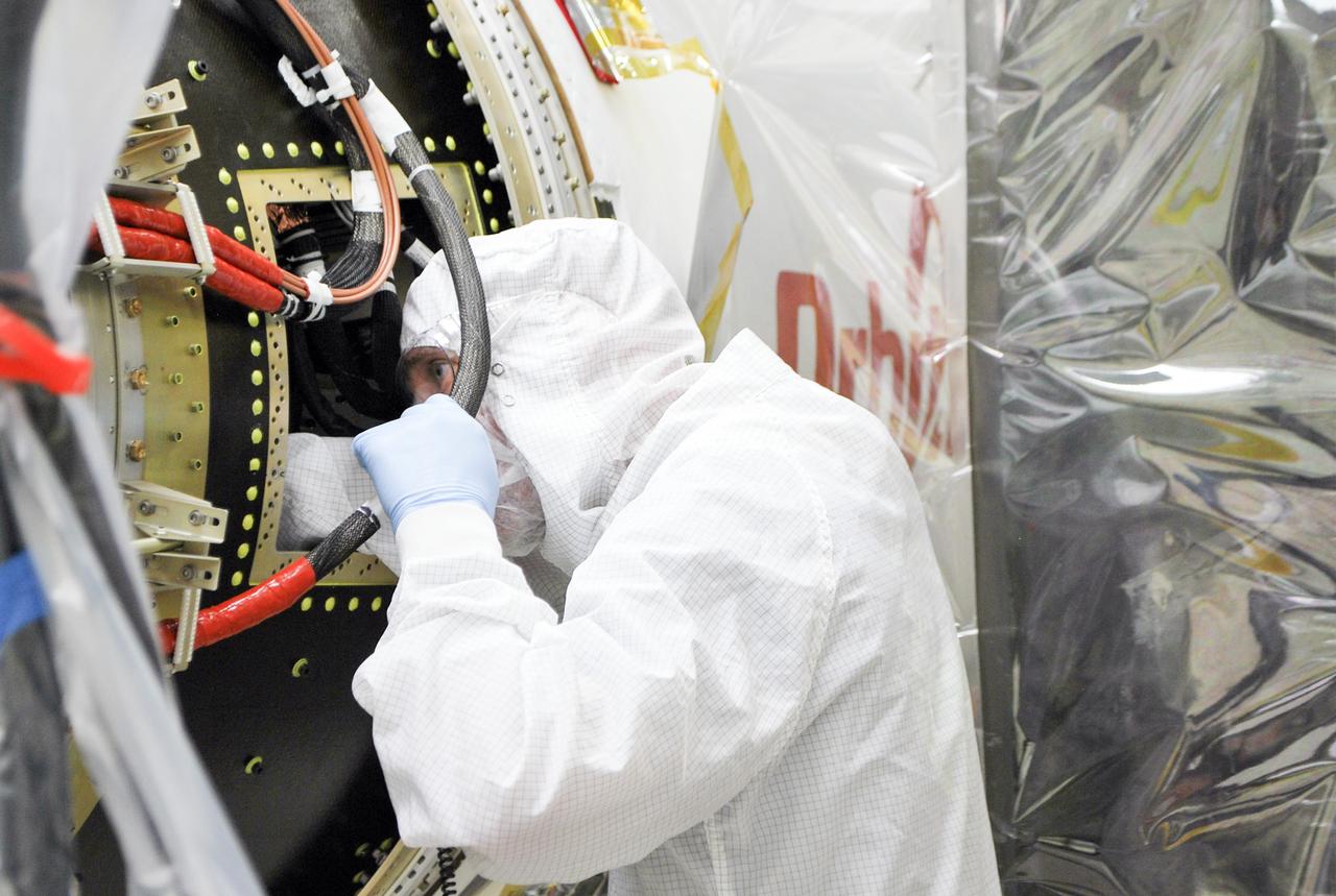 - VANDENBERG AFB – An engineer makes preparations on the starboard side of the payload fairing before it is connected into place for NASA's IRIS spacecraft. The fairing connects to the nose of the Orbital Sciences Pegasus XL rocket that will lift the solar observatory into orbit in June. The work is taking place in a hangar at Vandenberg Air Force Base where IRIS, short for Interface Region Imaging Spectrograph, is being prepared for launch on a Pegasus XL rocket. Scheduled for launch from Vandenberg June 26, IRIS will open a new window of discovery by tracing the flow of energy and plasma through the chromospheres and transition region into the sun’s corona using spectrometry and imaging. IRIS fills a crucial gap in our ability to advance studies of the sun-to-Earth connection by tracing the flow of energy and plasma through the foundation of the corona and the region around the sun known as the heliosphere. Photo credit: NASA/Randy Beaudoin