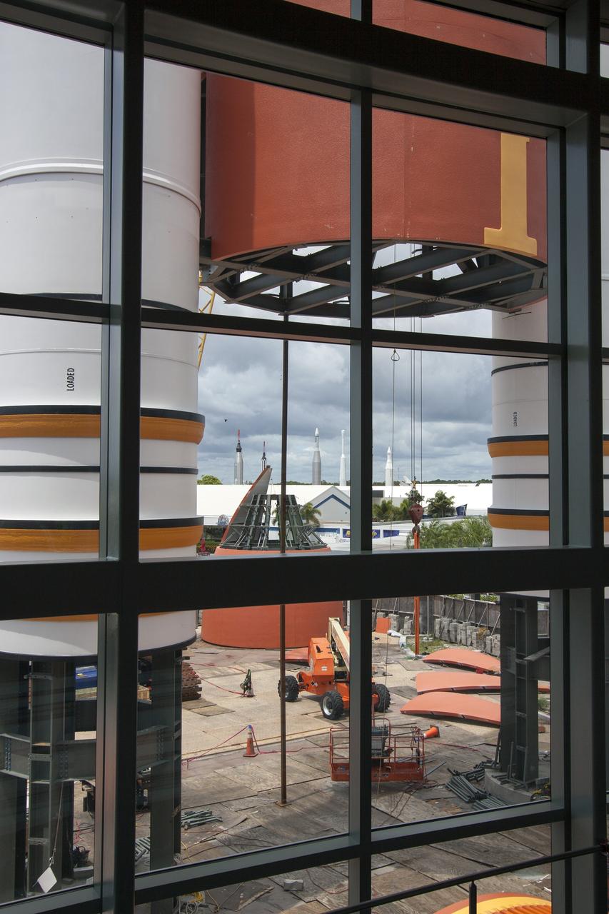 CAPE CANAVERAL, Fla. – A view from inside the new “Space Shuttle Atlantis” exhibit at the Kennedy Space Center Visitor Complex in Florida, shows the buildup of the replica solid rocket boosters and external fuel tank are nearly complete near the entrance. Atlantis is being prepared for display in the 90,000-square-foot facility, scheduled to open June 29, 2013.    The new $100 million facility will include interactive exhibits that tell the story of the 30-year Space Shuttle Program and highlight the future of space exploration. Visitors to the exhibit will get an up close look at Atlantis with its payload bay doors open, similar to how it looked in space. Photo credit: NASA/Jim Grossmann