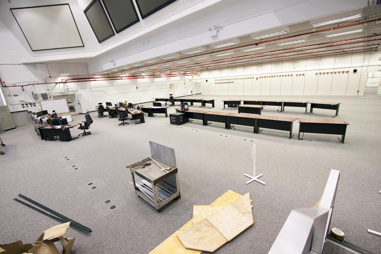 CAPE CANAVERAL, Fla. – At NASA’s Kennedy Space Center in Florida, modifications to Firing Room 3 in the Launch Control Center, or LCC, continue. Wiring and conduits below the floor have been upgraded. The legacy flooring was removed and new flooring has been installed. Some of the new launch control work stations are being positioned for installation in the room. Firing Rooms inside the LCC are being upgraded by the Ground System Development and Operations Program at Kennedy to support the processing and launch of multiple types of rockets and spacecraft, whether they are government or commercial models. Kennedy’s Launch Complex 39 is transitioning to support multiple users with the Firing Rooms being modified to be more generic in nature for upcoming programs. Photo credit: NASA/Jim Grossmann