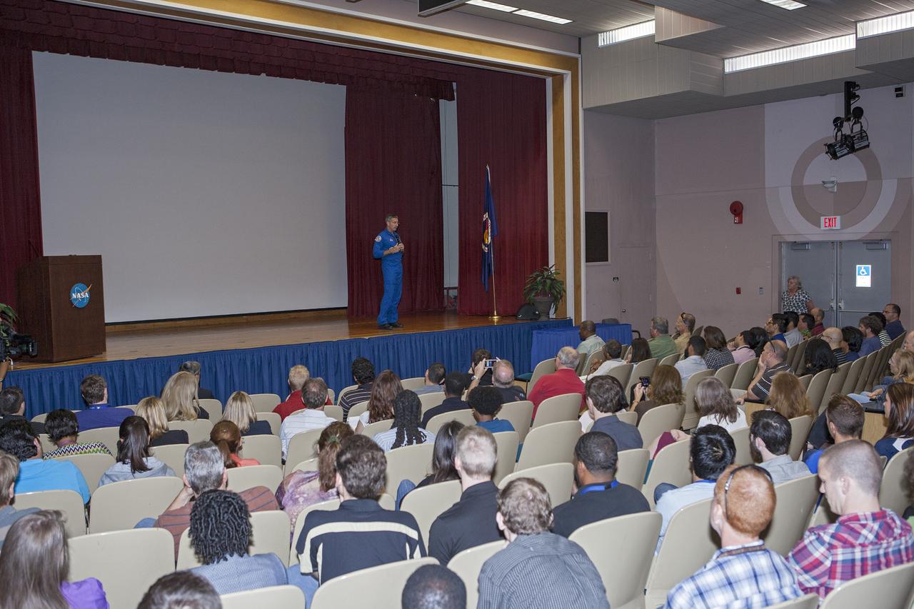 CAPE CANAVERAL, Fla. – NASA astronaut Dan Burbank, who served as commander of Expedition 30 aboard the International Space Station, reviews still and video imagery of life aboard the orbiting laboratory during his presentation to Kennedy Space Center employees.      Burbank spent 165 days aboard the station during expeditions 29 and 30. For more information on the space station, visit http://www.nasa.gov/mission_pages/station/expeditions/index.html  Photo credit: NASA/Kim Shiflett & Gianni Woods