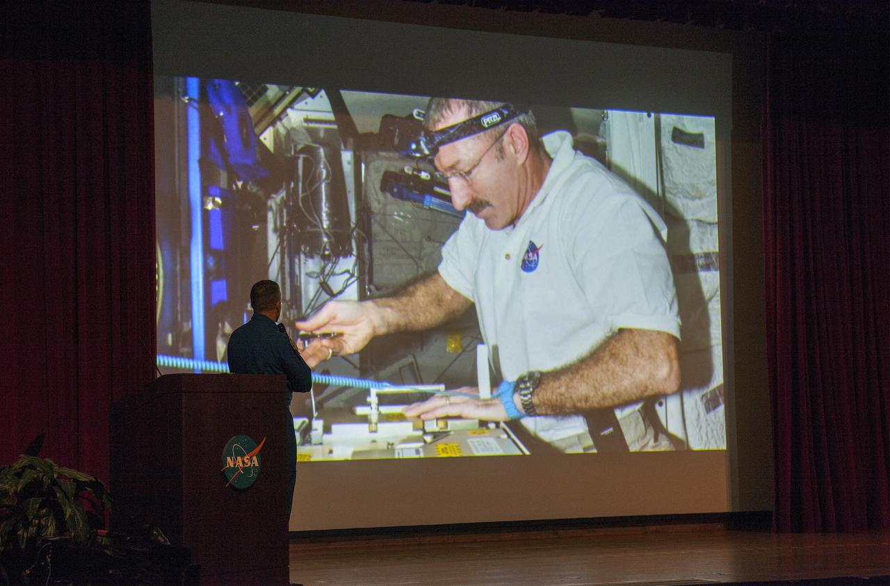 CAPE CANAVERAL, Fla. – NASA astronaut Dan Burbank, who served as commander of Expedition 30 aboard the International Space Station, reviews still and video imagery of life aboard the orbiting laboratory during his presentation to Kennedy Space Center employees.      Burbank spent 165 days aboard the station during expeditions 29 and 30. For more information on the space station, visit http://www.nasa.gov/mission_pages/station/expeditions/index.html  Photo credit: NASA/Kim Shiflett & Gianni Woods