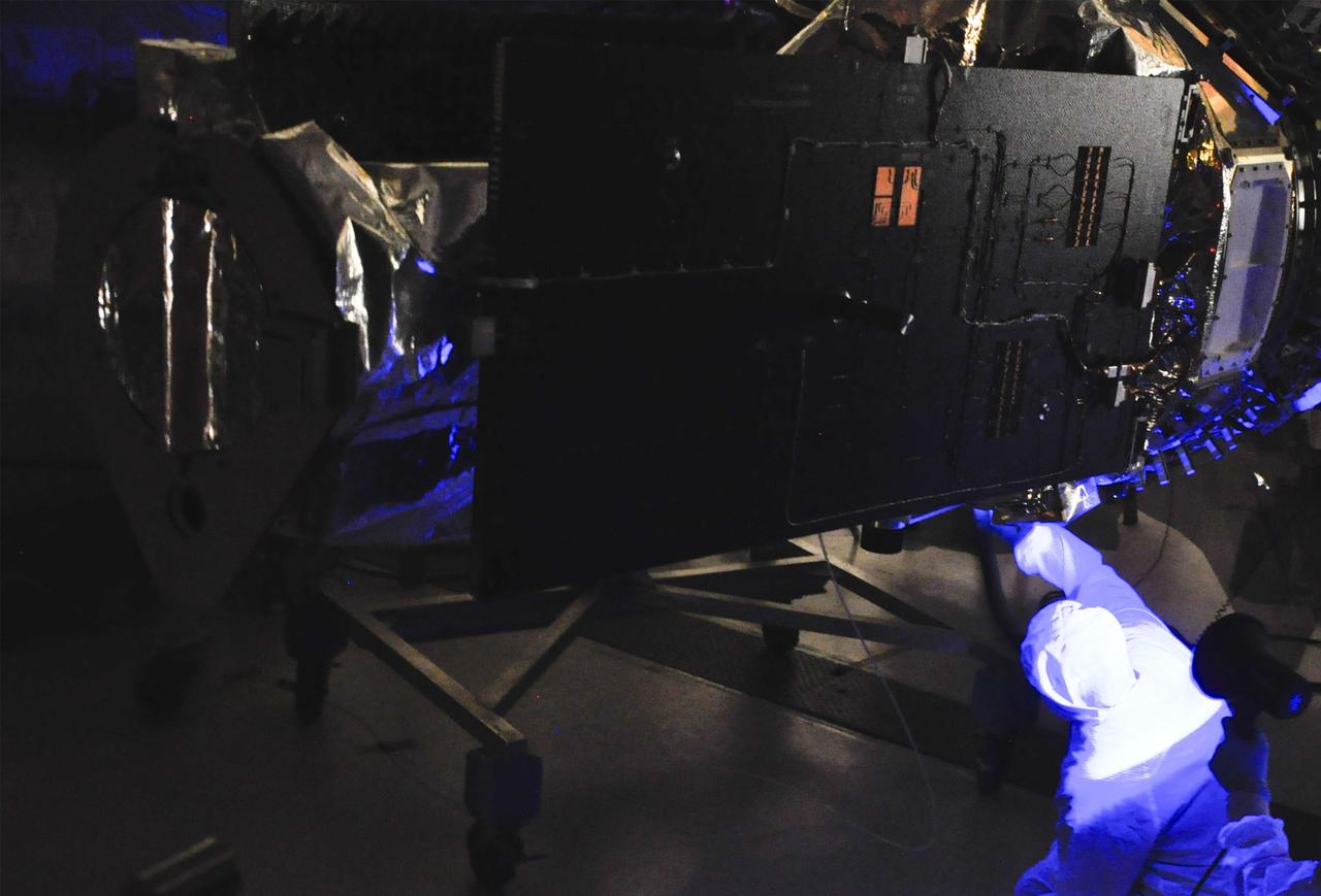 VANDENBERG AFB, Calif. – Engineers conduct inspections on NASA's IRIS spacecraft with blacklights before the payload fairing before it is connected. The fairing connects to the nose of the Orbital Sciences Pegasus XL rocket that will lift the solar observatory into orbit in June. The work is taking place in a hangar at Vandenberg Air Force Base where IRIS, short for Interface Region Imaging Spectrograph, is being prepared for launch on a Pegasus XL rocket. Scheduled for launch from Vandenberg June 26, IRIS will open a new window of discovery by tracing the flow of energy and plasma through the chromospheres and transition region into the sun’s corona using spectrometry and imaging. IRIS fills a crucial gap in our ability to advance studies of the sun-to-Earth connection by tracing the flow of energy and plasma through the foundation of the corona and the region around the sun known as the heliosphere. Photo credit: NASA/Randy Beaudoin