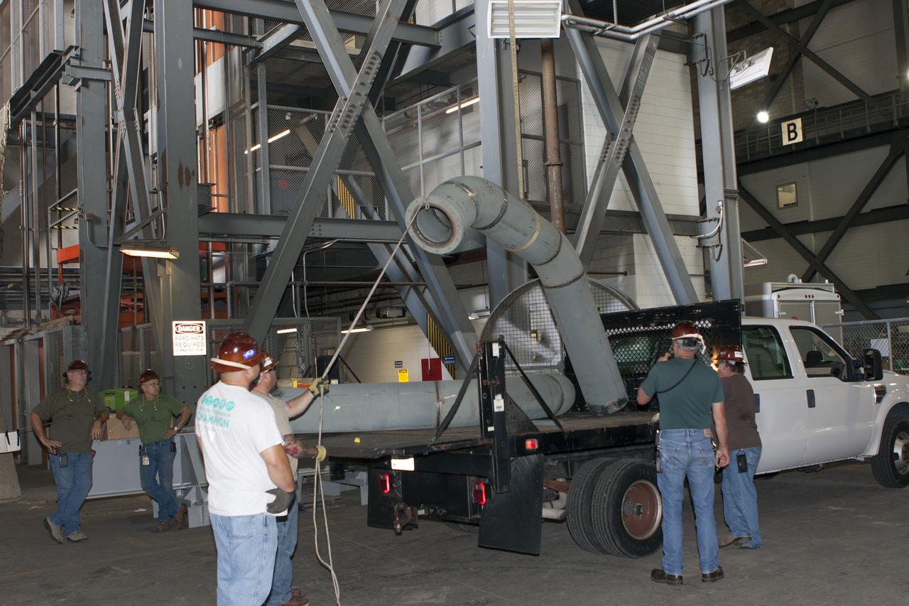 CAPE CANAVERAL, Fla. – Inside the Vehicle Assembly Building at NASA’s Kennedy Space Center in Florida, technicians prepare piping for a new exhaust system for installation in crawler-transporter 1, or CT-1. Work continues in high bay 3 to upgrade CT-1 as part of its general maintenance. CT-1 could be available to carry commercial launch vehicles to the launch pad. The crawler-transporters were used to carry the mobile launcher platform and space shuttle to Launch Complex 39 for space shuttle launches for 30 years. Photo credit: NASA/Jim Grossmann