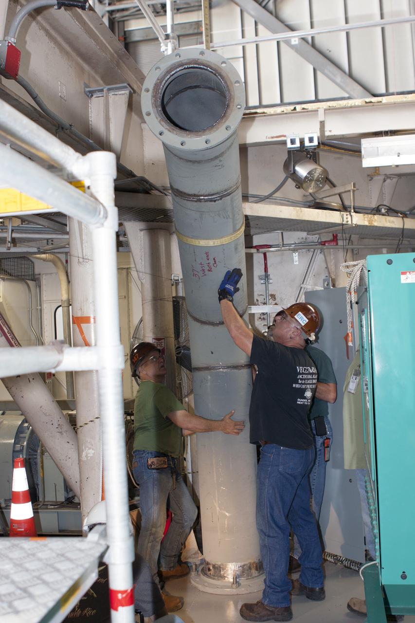 CAPE CANAVERAL, Fla. – Inside the Vehicle Assembly Building at NASA’s Kennedy Space Center in Florida, technicians install the piping for a new exhaust system in crawler-transporter 1, or CT-1. Work continues in high bay 3 to upgrade CT-1 as part of its general maintenance. CT-1 could be available to carry commercial launch vehicles to the launch pad. The crawler-transporters were used to carry the mobile launcher platform and space shuttle to Launch Complex 39 for space shuttle launches for 30 years. Photo credit: NASA/Jim Grossmann