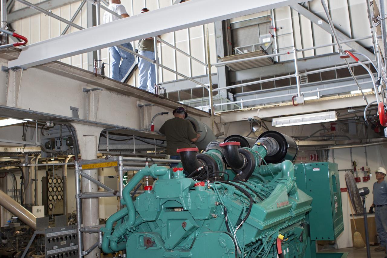 CAPE CANAVERAL, Fla. – Inside the Vehicle Assembly Building at NASA’s Kennedy Space Center in Florida, technicians install the piping for a new exhaust system in crawler-transporter 1, or CT-1. Work continues in high bay 3 to upgrade CT-1 as part of its general maintenance. CT-1 could be available to carry commercial launch vehicles to the launch pad. The crawler-transporters were used to carry the mobile launcher platform and space shuttle to Launch Complex 39 for space shuttle launches for 30 years. Photo credit: NASA/Jim Grossmann
