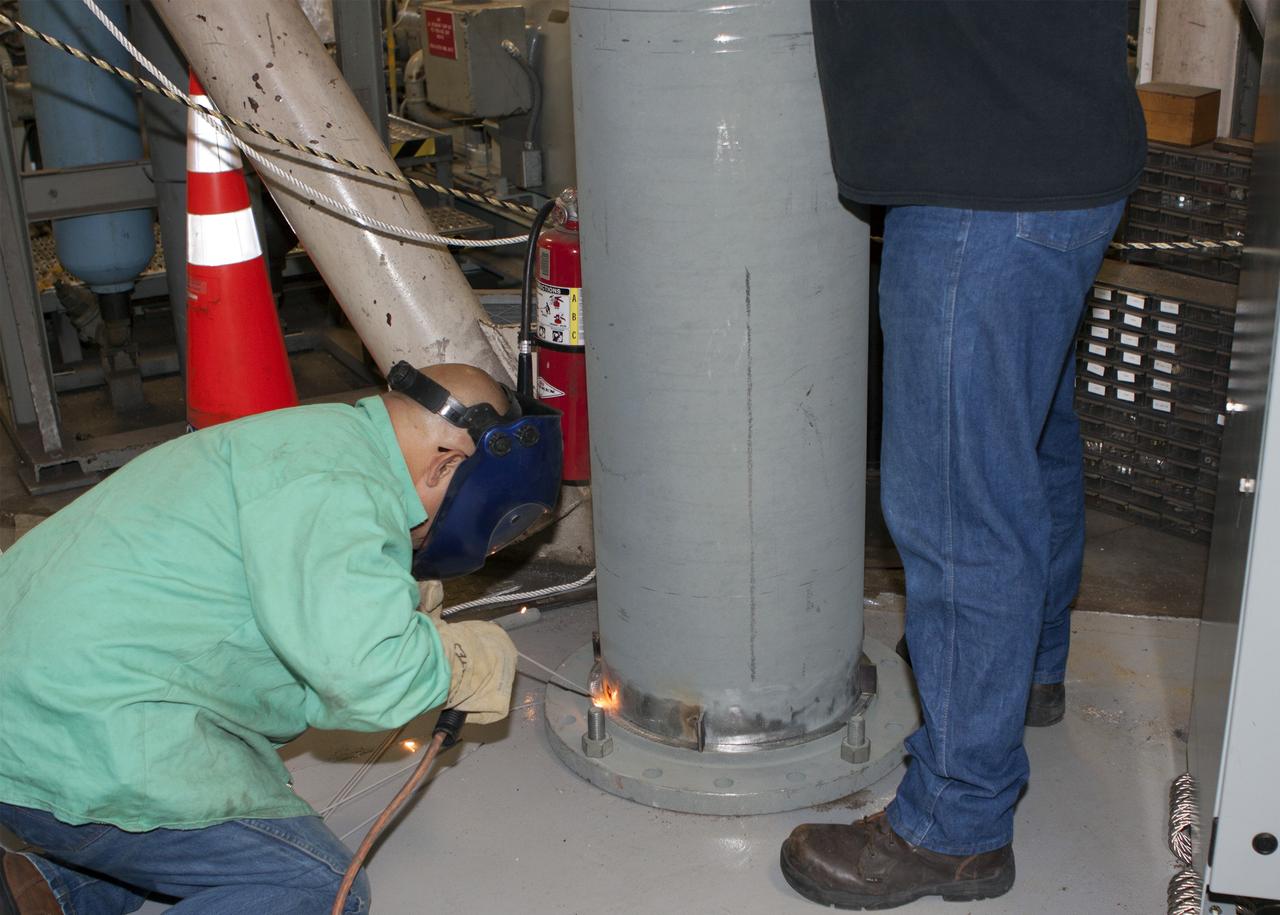 CAPE CANAVERAL, Fla. – Inside the Vehicle Assembly Building at NASA’s Kennedy Space Center in Florida, technicians install the piping for a new exhaust system in crawler-transporter 1, or CT-1. Work continues in high bay 3 to upgrade CT-1 as part of its general maintenance. CT-1 could be available to carry commercial launch vehicles to the launch pad. The crawler-transporters were used to carry the mobile launcher platform and space shuttle to Launch Complex 39 for space shuttle launches for 30 years. Photo credit: NASA/Jim Grossmann