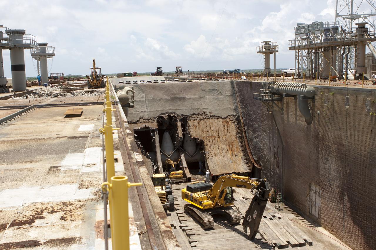 CAPE CANAVERAL, Fla. – At Launch Pad 39B at NASA’s Kennedy Space Center in Florida, workers are removing the flame trench deflector that sits below and between the left and right crawler track panels.    Launch Pad 39B is being refurbished to support NASA’s Space Launch System and other launch vehicles. The Ground Systems Development and Operations, or GSDO, Program office at Kennedy is leading the center’s transformation to safely handle a variety of rockets and spacecraft. For more information about GSDO, visit: http://go.nasa.gov/groundsystems. Photo credit: NASA/Jim Grossman