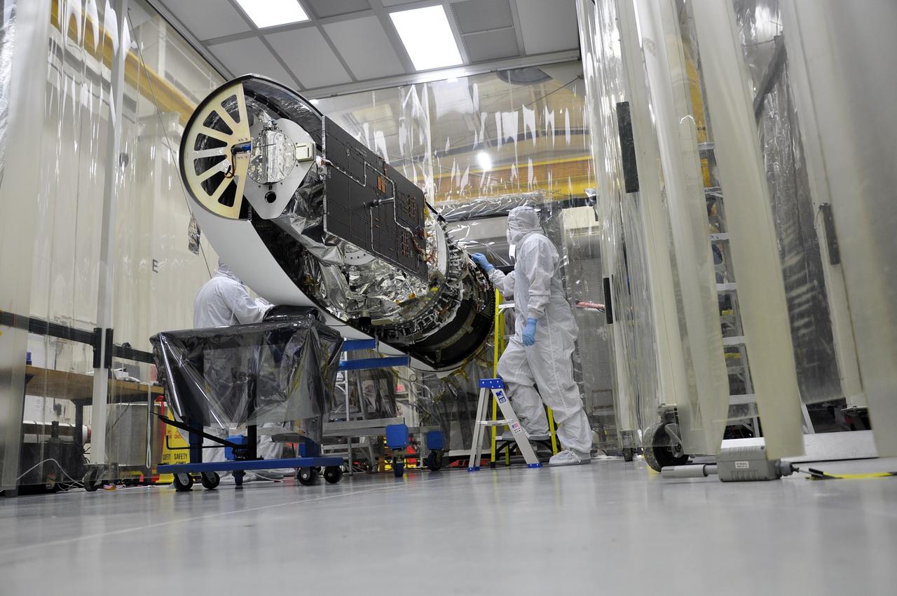 VANDENBERG AFB – Engineers attach the starboard side of the payload fairing into place for NASA's IRIS spacecraft. The fairing connects to the nose of the Orbital Sciences Pegasus XL rocket that will lift the solar observatory into orbit in June. The work is taking place in a hangar at Vandenberg Air Force Base where IRIS, short for Interface Region Imaging Spectrograph, is being prepared for launch on a Pegasus XL rocket. Scheduled for launch from Vandenberg June 26, IRIS will open a new window of discovery by tracing the flow of energy and plasma through the chromospheres and transition region into the sun’s corona using spectrometry and imaging. IRIS fills a crucial gap in our ability to advance studies of the sun-to-Earth connection by tracing the flow of energy and plasma through the foundation of the corona and the region around the sun known as the heliosphere. Photo credit: NASA/Randy Beaudoin