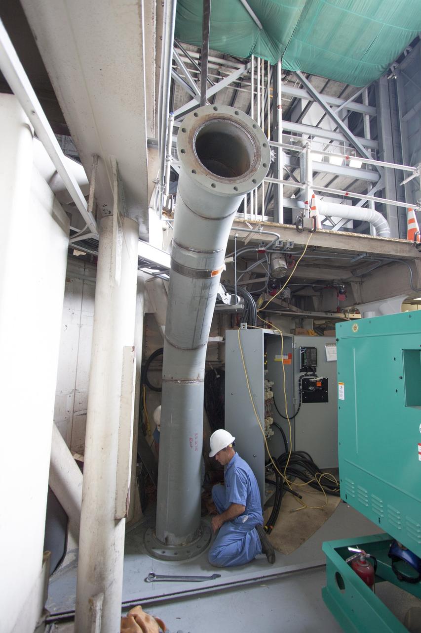 CAPE CANAVERAL, Fla. – Inside the Vehicle Assembly Building at NASA’s Kennedy Space Center in Florida, technicians install piping for a new exhaust system in crawler-transporter 1, or CT-1. Work continues in high bay 3 to upgrade CT-1 as part of its general maintenance. CT-1 could be available to carry commercial launch vehicles to the launch pad. The crawler-transporters were used to carry the mobile launcher platform and space shuttle to Launch Complex 39 for space shuttle launches for 30 years. Photo credit: NASA/Jim Grossmann