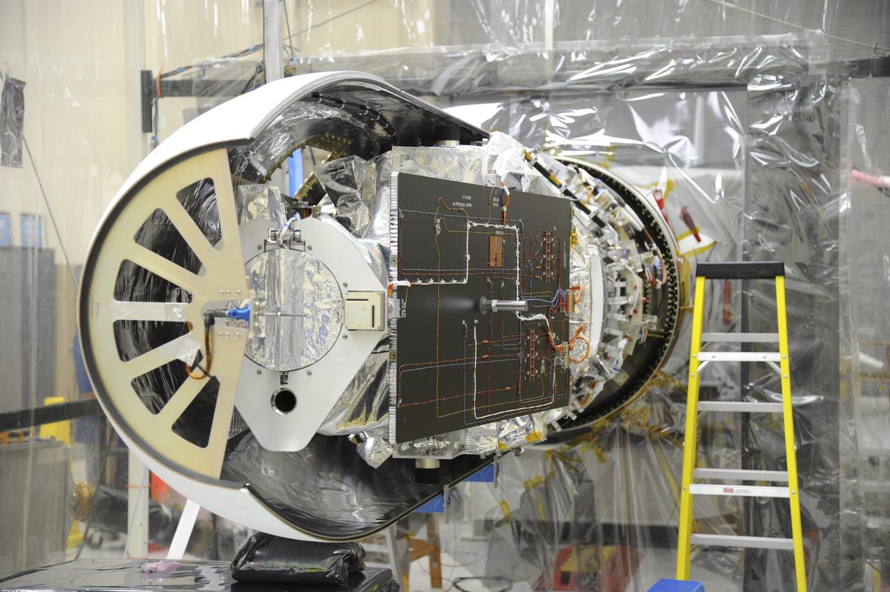 VANDENBERG AFB – NASA's IRIS spacecraft before the second half of the payload fairing is installed over it. The fairing connects to the nose of the Orbital Sciences Pegasus XL rocket that will lift the solar observatory into orbit in June. The work is taking place in a hangar at Vandenberg Air Force Base where IRIS, short for Interface Region Imaging Spectrograph, is being prepared for launch on a Pegasus XL rocket. Scheduled for launch from Vandenberg June 26, IRIS will open a new window of discovery by tracing the flow of energy and plasma through the chromospheres and transition region into the sun’s corona using spectrometry and imaging. IRIS fills a crucial gap in our ability to advance studies of the sun-to-Earth connection by tracing the flow of energy and plasma through the foundation of the corona and the region around the sun known as the heliosphere. Photo credit: NASA/Tony Vauclin