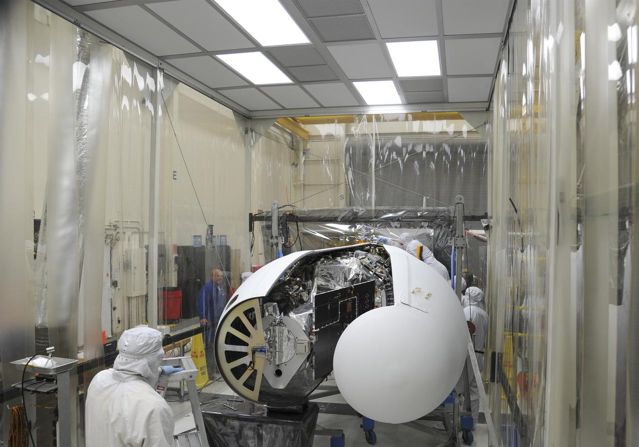 VANDENBERG AFB – Orbital Sciences engineers connect the payload fairing over NASA's IRIS spacecraft. The fairing connects to the nose of the Orbital Sciences Pegasus XL rocket that will lift the solar observatory into orbit in June. The work is taking place in a hangar at Vandenberg Air Force Base where IRIS, short for Interface Region Imaging Spectrograph, is being prepared for launch on a Pegasus XL rocket. Scheduled for launch from Vandenberg June 26, IRIS will open a new window of discovery by tracing the flow of energy and plasma through the chromospheres and transition region into the sun’s corona using spectrometry and imaging. IRIS fills a crucial gap in our ability to advance studies of the sun-to-Earth connection by tracing the flow of energy and plasma through the foundation of the corona and the region around the sun known as the heliosphere. Photo credit: NASA/Tony Vauclin