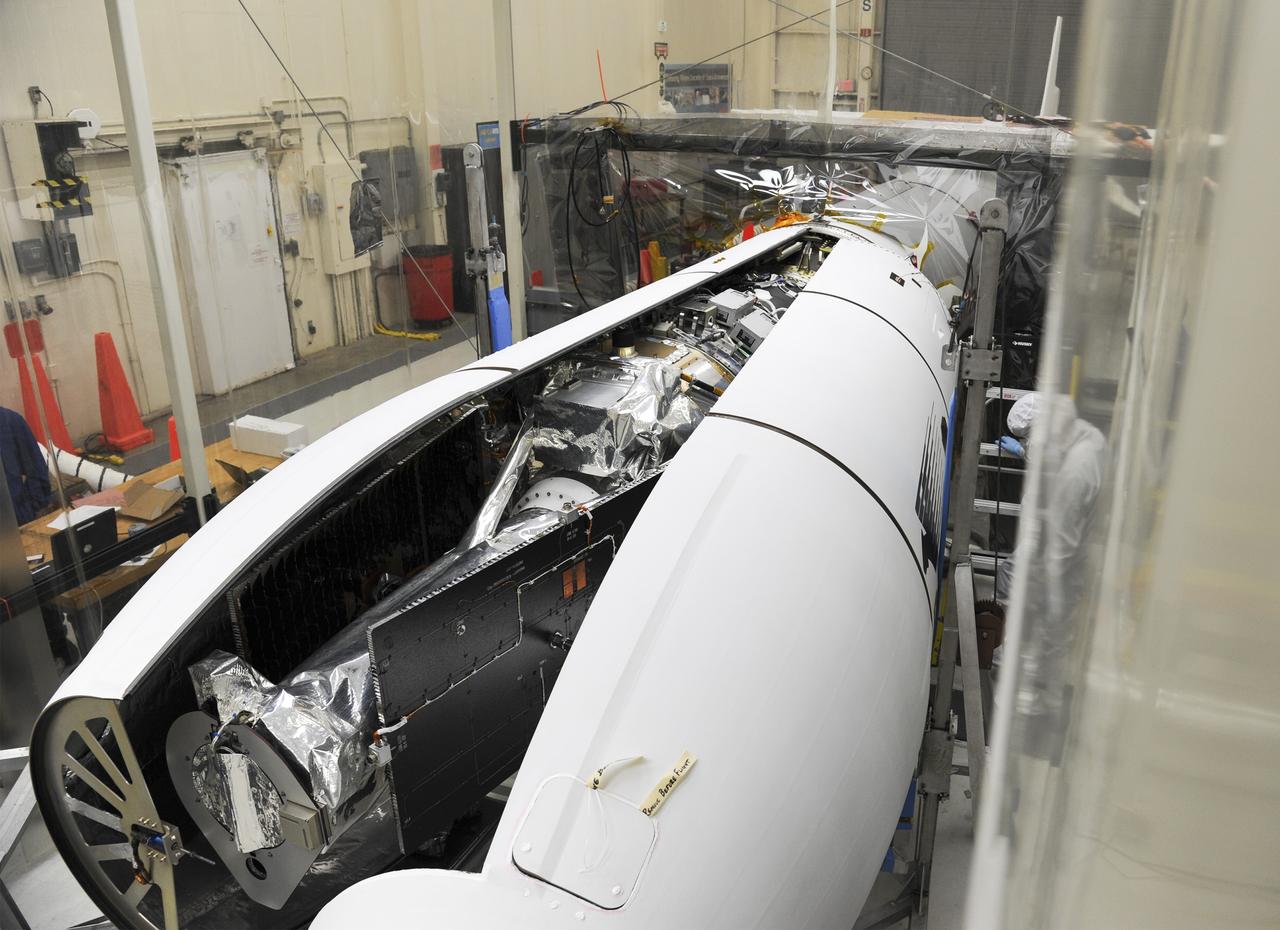 VANDENBERG AFB – Orbital Sciences engineers connect the payload fairing over NASA's IRIS spacecraft. The fairing connects to the nose of the Orbital Sciences Pegasus XL rocket that will lift the solar observatory into orbit in June. The work is taking place in a hangar at Vandenberg Air Force Base where IRIS, short for Interface Region Imaging Spectrograph, is being prepared for launch on a Pegasus XL rocket. Scheduled for launch from Vandenberg June 26, IRIS will open a new window of discovery by tracing the flow of energy and plasma through the chromospheres and transition region into the sun’s corona using spectrometry and imaging. IRIS fills a crucial gap in our ability to advance studies of the sun-to-Earth connection by tracing the flow of energy and plasma through the foundation of the corona and the region around the sun known as the heliosphere. Photo credit: NASA/Tony Vauclin