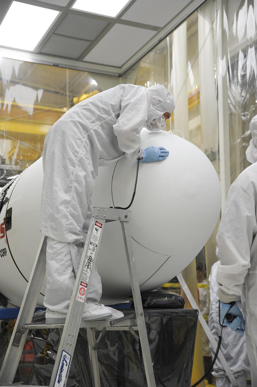 VANDENBERG AFB – Orbital Sciences engineers connect the payload fairing over NASA's IRIS spacecraft. The fairing connects to the nose of the Orbital Sciences Pegasus XL rocket that will lift the solar observatory into orbit in June. The work is taking place in a hangar at Vandenberg Air Force Base where IRIS, short for Interface Region Imaging Spectrograph, is being prepared for launch on a Pegasus XL rocket. Scheduled for launch from Vandenberg June 26, IRIS will open a new window of discovery by tracing the flow of energy and plasma through the chromospheres and transition region into the sun’s corona using spectrometry and imaging. IRIS fills a crucial gap in our ability to advance studies of the sun-to-Earth connection by tracing the flow of energy and plasma through the foundation of the corona and the region around the sun known as the heliosphere. Photo credit: NASA/Tony Vauclin