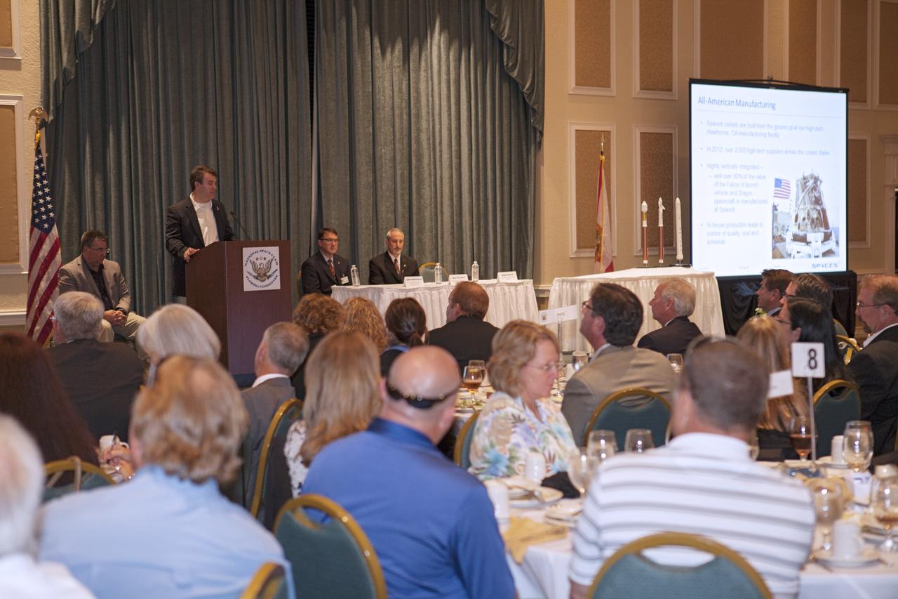 CAPE CANAVERAL, Fla. - Adam Harris, vice president of government sales for Space Exploration Technologies, or SpaceX, speaks to a crowd of spaceflight enthusiasts at the National Space Club Florida Committee's June meeting near the Kennedy Space Center. Harris was joined at the Radisson Resort at the Port in Cape Canaveral, Fla., by Ed Mango, manager of NASA's Commercial Crew Program, or CCP, left, and representatives from The Boeing Company and Sierra Nevada Corporation, or SNC. All three CCP partner are planning to increase their commercial activities on Florida’s space coast to send astronauts to low-Earth orbit.      To learn more about the Commercial Crew Program, visit www.nasa.gov/commercialcrew. Photo credit: Kim Shiflett