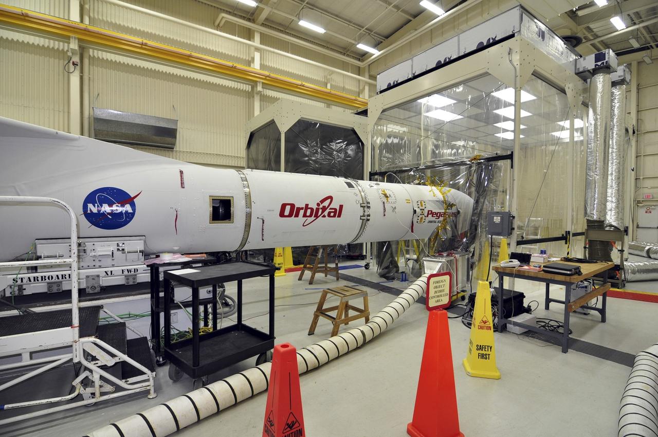 VANDENBERG ABF, Calif. - The Orbital Sciences Pegasus XL rocket that will lift NASA's IRIS solar observatory into orbit in June is seen in a hangar at Vandenberg Air Force Base. IRIS, short for Interface Region Imaging Spectrograph, is being prepared for launch from Vandenberg June 26. IRIS will open a new window of discovery by tracing the flow of energy and plasma through the chromospheres and transition region into the sun’s corona using spectrometry and imaging. IRIS fills a crucial gap in our ability to advance studies of the sun-to-Earth connection by tracing the flow of energy and plasma through the foundation of the corona and the region around the sun known as the heliosphere. Photo credit: VAFB/Randy Beaudoin