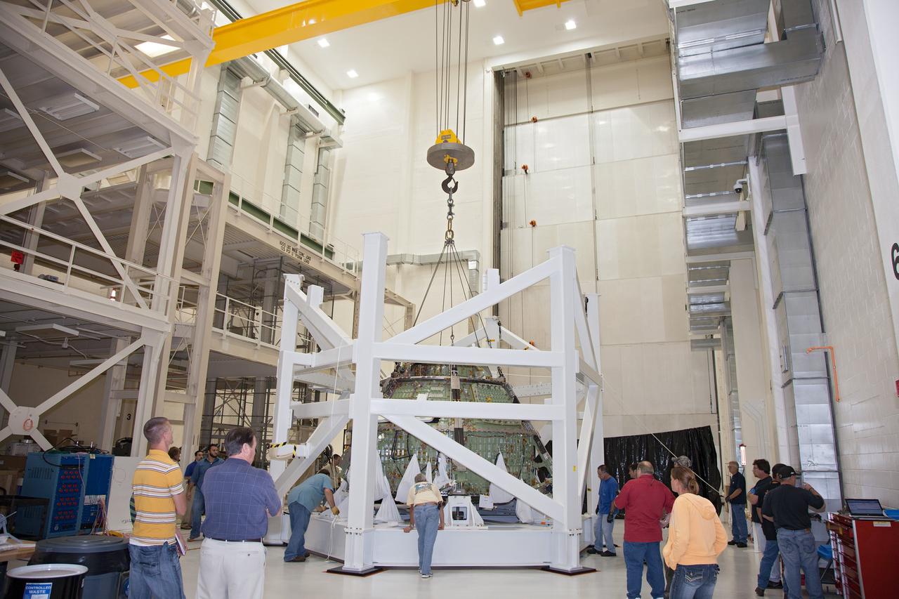 CAPE CANAVERAL, Fla. – Inside the Operations and Checkout Building high bay at NASA’s Kennedy Space Center in Florida, technicians and engineers monitor the progress as a crane is used to lift the Orion crew module from a special test stand. Lockheed Martin Space Systems and NASA engineers performed a series of static load tests on Orion that simulated the massive loads the spacecraft would experience during its mission.    Orion is the exploration spacecraft designed to carry crews to space beyond low Earth orbit. It will provide emergency abort capability, sustain the crew during the space travel and provide safe re-entry from deep space return velocities. Orion’s first unpiloted test flight, Exploration Flight Test 1, is scheduled to launch in 2014 atop a Delta IV rocket. A second uncrewed flight test is scheduled for 2017 on NASA’s Space Launch System rocket. For more information, visit http://www.nasa.gov/orion. Photo credit: NASA/Daniel Casper
