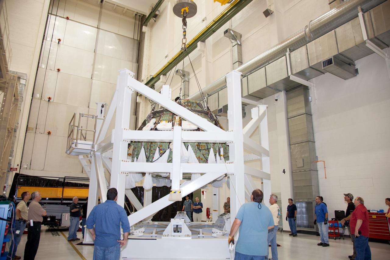 CAPE CANAVERAL, Fla. – Inside the Operations and Checkout Building high bay at NASA’s Kennedy Space Center in Florida, technicians and engineers monitor the progress as a crane is used to lift the Orion crew module from a special test stand. Lockheed Martin Space Systems and NASA engineers performed a series of static load tests on Orion that simulated the massive loads the spacecraft would experience during its mission.    Orion is the exploration spacecraft designed to carry crews to space beyond low Earth orbit. It will provide emergency abort capability, sustain the crew during the space travel and provide safe re-entry from deep space return velocities. Orion’s first unpiloted test flight, Exploration Flight Test 1, is scheduled to launch in 2014 atop a Delta IV rocket. A second uncrewed flight test is scheduled for 2017 on NASA’s Space Launch System rocket. For more information, visit http://www.nasa.gov/orion. Photo credit: NASA/Daniel Casper