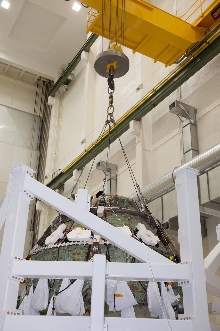 CAPE CANAVERAL, Fla. – Inside the Operations and Checkout Building high bay at NASA’s Kennedy Space Center in Florida, a crane lifts the Orion crew module out of a special test stand. Lockheed Martin Space Systems and NASA engineers performed a series of static load tests on Orion that simulated the massive loads the spacecraft would experience during its mission. Orion is the exploration spacecraft designed to carry crews to space beyond low Earth orbit. It will provide emergency abort capability, sustain the crew during the space travel and provide safe re-entry from deep space return velocities. Orion’s first unpiloted test flight, Exploration Flight Test 1, is scheduled to launch in 2014 atop a Delta IV rocket. A second uncrewed flight test is scheduled for 2017 on NASA’s Space Launch System rocket. For more information, visit http://www.nasa.gov/orion. Photo credit: NASA/Daniel Casper