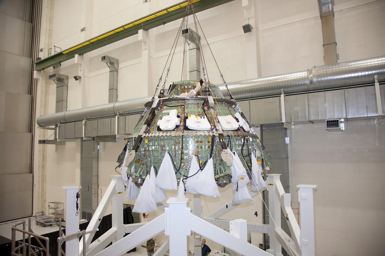 CAPE CANAVERAL, Fla. – Inside the Operations and Checkout Building high bay at NASA’s Kennedy Space Center in Florida, a crane lifts the Orion crew module out of a special test stand. Lockheed Martin Space Systems and NASA engineers performed a series of static load tests on Orion that simulated the massive loads the spacecraft would experience during its mission. Orion is the exploration spacecraft designed to carry crews to space beyond low Earth orbit. It will provide emergency abort capability, sustain the crew during the space travel and provide safe re-entry from deep space return velocities. Orion’s first unpiloted test flight, Exploration Flight Test 1, is scheduled to launch in 2014 atop a Delta IV rocket. A second uncrewed flight test is scheduled for 2017 on NASA’s Space Launch System rocket. For more information, visit http://www.nasa.gov/orion. Photo credit: NASA/Daniel Casper