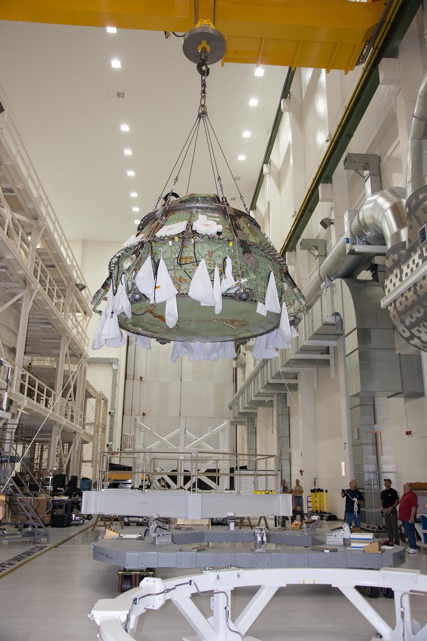 CAPE CANAVERAL, Fla. – Inside the Operations and Checkout Building high bay at NASA’s Kennedy Space Center in Florida, a crane has lifted the Orion crew module out of a special test stand and is lowering the module onto another test stand. Lockheed Martin Space Systems and NASA engineers performed a series of static load tests on Orion that simulated the massive loads the spacecraft would experience during its mission. Orion is the exploration spacecraft designed to carry crews to space beyond low Earth orbit. It will provide emergency abort capability, sustain the crew during the space travel and provide safe re-entry from deep space return velocities. Orion’s first unpiloted test flight, Exploration Flight Test 1, is scheduled to launch in 2014 atop a Delta IV rocket. A second uncrewed flight test is scheduled for 2017 on NASA’s Space Launch System rocket. For more information, visit http://www.nasa.gov/orion. Photo credit: NASA/Daniel Casper