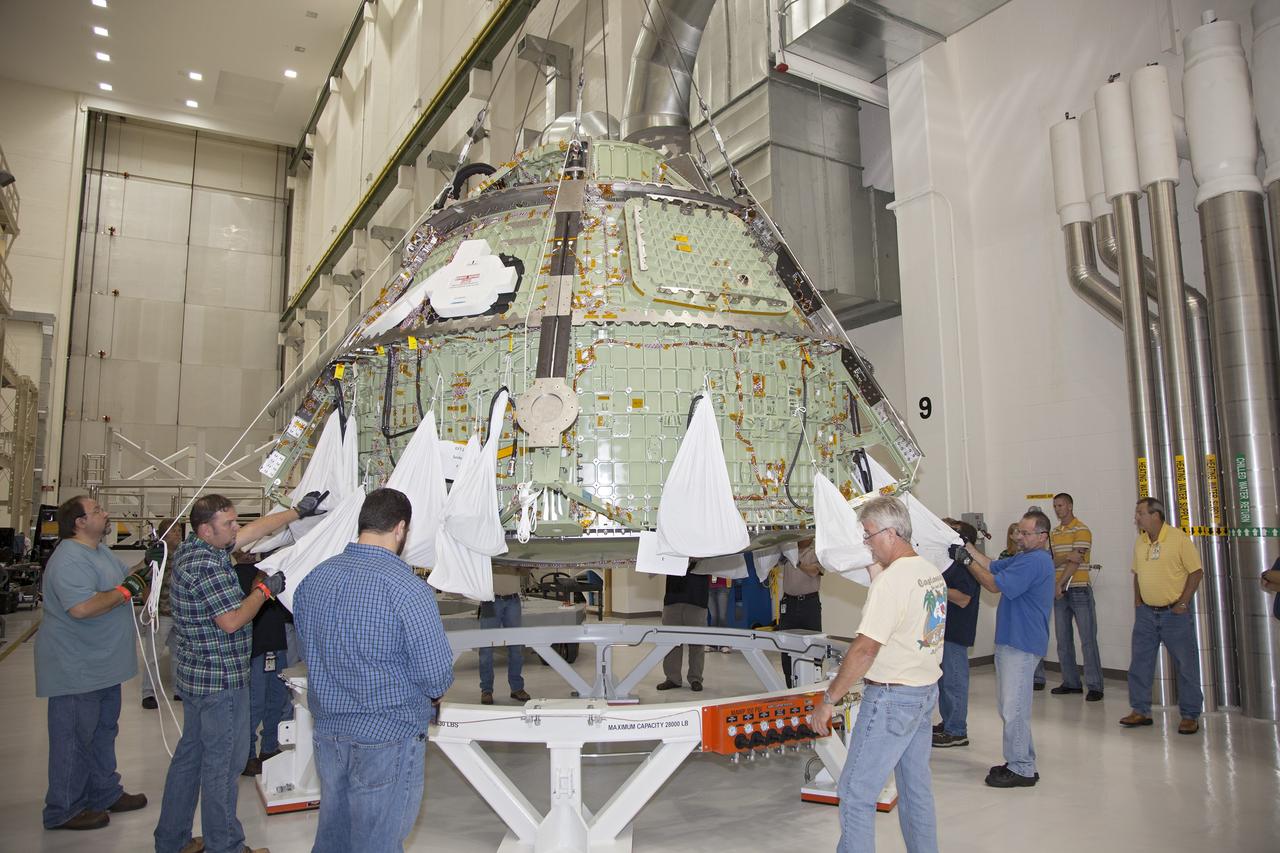 CAPE CANAVERAL, Fla. – Inside the Operations and Checkout Building high bay at NASA’s Kennedy Space Center in Florida, technicians monitor the progress and assist as a crane lowers the Orion crew module onto a work stand after it was lifted out of a special test stand. Lockheed Martin Space Systems and NASA engineers performed a series of static load tests on Orion that simulated the massive loads the spacecraft would experience during its mission.    Orion is the exploration spacecraft designed to carry crews to space beyond low Earth orbit. It will provide emergency abort capability, sustain the crew during the space travel and provide safe re-entry from deep space return velocities. Orion’s first unpiloted test flight, Exploration Flight Test 1, is scheduled to launch in 2014 atop a Delta IV rocket. A second uncrewed flight test is scheduled for 2017 on NASA’s Space Launch System rocket. For more information, visit http://www.nasa.gov/orion. Photo credit: NASA/Daniel Casper