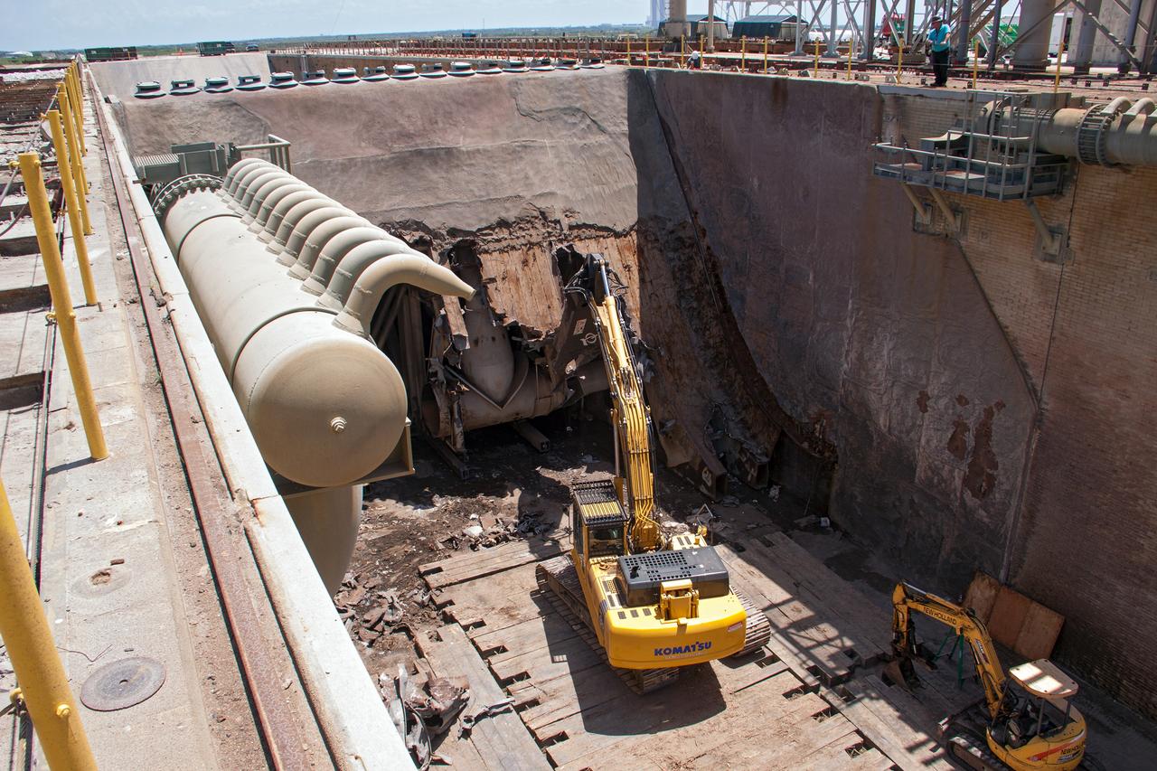 CAPE CANAVERAL, Fla. – At Launch Pad 39B at NASA’s Kennedy Space Center in Florida, construction workers continue to remove the flame trench deflector that sits below and between the left and right crawlerway tracks.    Launch Pad 39B is being refurbished to support NASA’s Space Launch System and other launch vehicles. The Ground Systems Development and Operations, or GSDO, Program office at Kennedy is leading the center’s transformation to safely handle a variety of rockets and spacecraft. For more information about GSDO, visit: http://go.nasa.gov/groundsystems. Photo credit: NASA/Jim Grossman