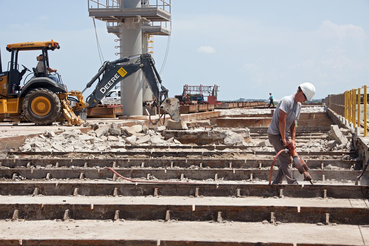 CAPE CANAVERAL, Fla. – At Launch Pad 39B at NASA’s Kennedy Space Center in Florida, crawler track panels have been removed from the surface and construction workers are repairing the concrete surface and catacomb roof below.     Launch Pad 39B is being refurbished to support NASA’s Space Launch System and other launch vehicles. The Ground Systems Development and Operations, or GSDO, Program office at Kennedy is leading the center’s transformation to safely handle a variety of rockets and spacecraft. For more information about GSDO, visit: http://go.nasa.gov/groundsystems. Photo credit: NASA/Jim Grossman