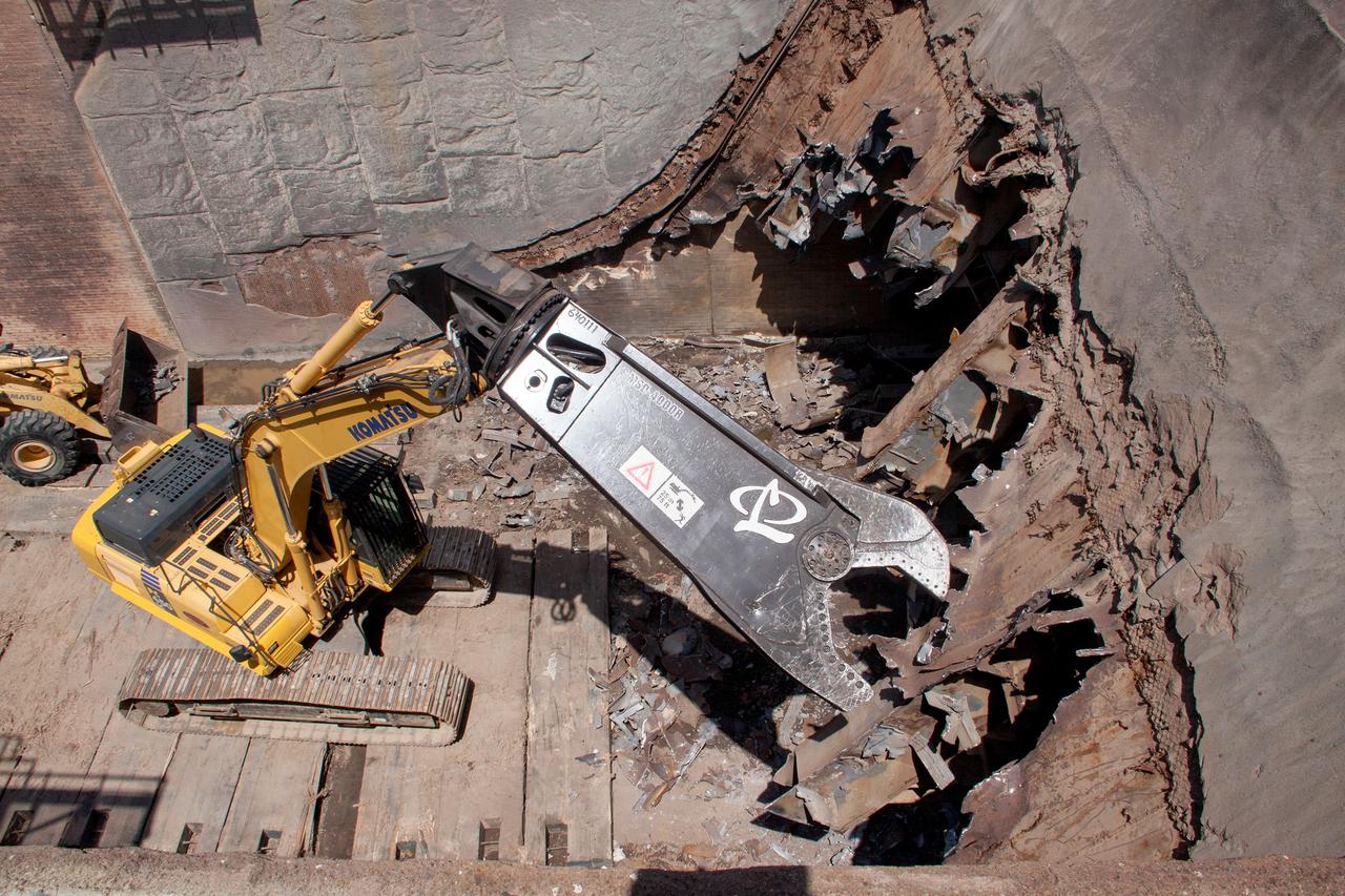 CAPE CANAVERAL, Fla. – At Launch Pad 39B at NASA’s Kennedy Space Center in Florida, construction workers continue to remove the flame trench deflector that sits below and between the left and right crawlerway tracks.     Launch Pad 39B is being refurbished to support NASA’s Space Launch System and other launch vehicles. The Ground Systems Development and Operations, or GSDO, Program office at Kennedy is leading the center’s transformation to safely handle a variety of rockets and spacecraft. For more information about GSDO, visit: http://go.nasa.gov/groundsystems. Photo credit: NASA/Jim Grossman
