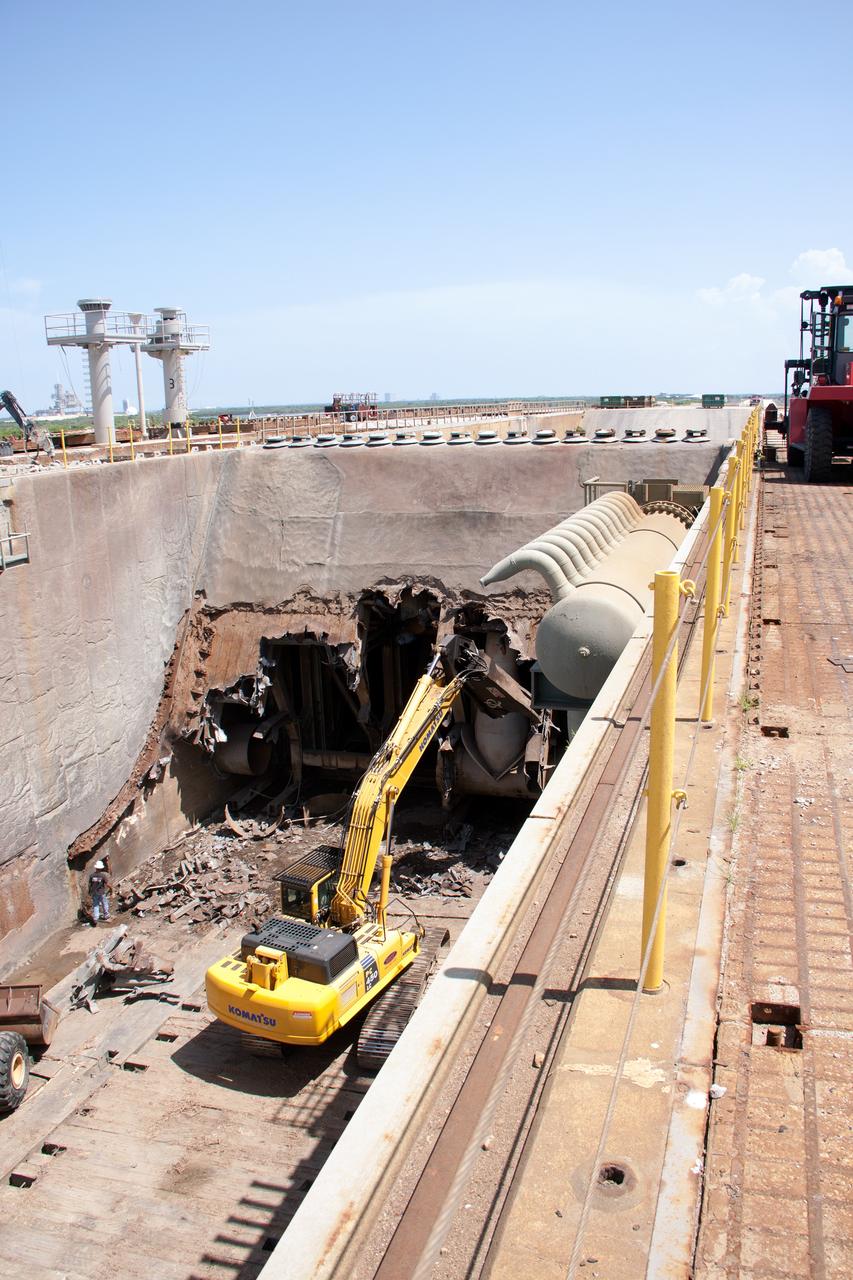 CAPE CANAVERAL, Fla. – At Launch Pad 39B at NASA’s Kennedy Space Center in Florida, construction workers continue to remove the flame trench deflector that sits below and between the left and right crawlerway tracks.     Launch Pad 39B is being refurbished to support NASA’s Space Launch System and other launch vehicles. The Ground Systems Development and Operations, or GSDO, Program office at Kennedy is leading the center’s transformation to safely handle a variety of rockets and spacecraft. For more information about GSDO, visit: http://go.nasa.gov/groundsystems. Photo credit: NASA/Jim Grossman
