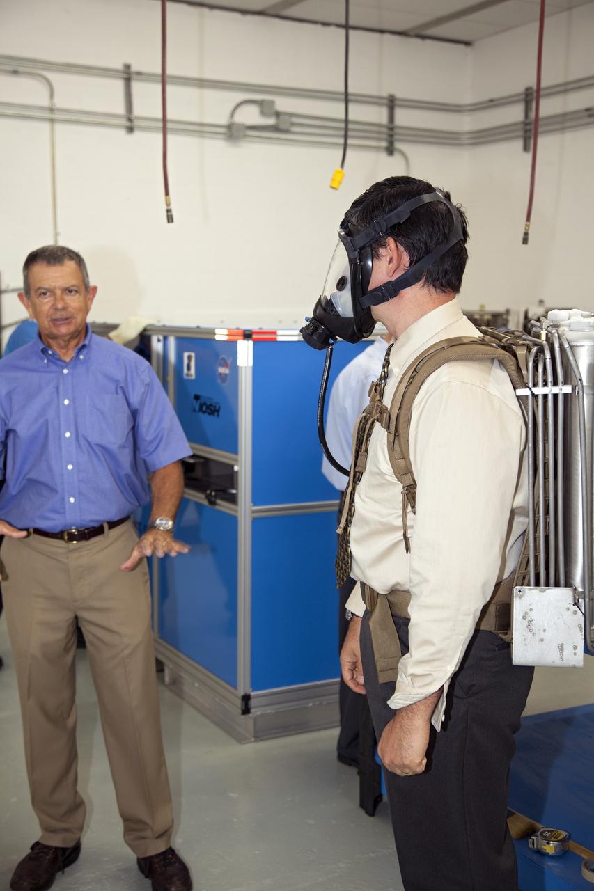 TITUSVILLE, Fla. - NASA Kennedy Space Center Lead Engineer David Bush, right, demos a small liquid-air filled backpack called CryoBA, short for Cryogenic Breathing Apparatus, at BCS Life Support in Titusville, Fla. The CryoBA and a larger Cryogenic Refuge Alternative Supply System, or CryoRASS, are being developed by a Kennedy engineering team in collaboration with The National Institute for Occupational Safety and Health to provide miners with twice the amount of breathable and cooler air than traditional compressed systems. The technology also could be used for commercial applications, such as fire and military rescue operations, as well as NASA's future human spaceflight missions. Photo credit: NASA/Daniel Casper