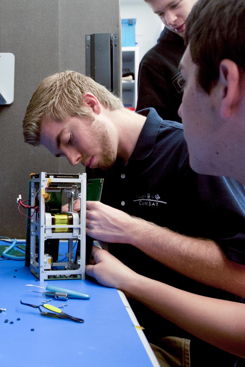 SAN LUIS OBISPO, Calif. – A member of the student launch team for the Polysat works through final checks in the CubeSat lab facility at California Polytechnic Institute, or CalPoly. The payloads, which include sensors and equipment carefully packaged into 4-inch cubes, will ride in the body of a Garvey Spacecraft Corporation's Prospector P-18D rocket during a June 15 launch on a high-altitude, suborbital flight. Collectively known as CubeSats, the satellites will record shock, vibrations and heat inside the rocket. They will not be released during the test flight, but the results will be used to prove or strengthen their designs before they are carried into orbit in 2014 on a much larger rocket. A new, lightweight carrier is also being tested for use on future missions to deploy the small spacecraft. The flight also is being watched closely as a model for trying out new or off-the-shelf technologies quickly before putting them in the pipeline for use on NASA's largest launchers. Built by several different organizations, including a university, a NASA field center and a high school, the spacecraft are four-inch cubes designed to fly on their own eventually, but will remain firmly attached to the rocket during the upcoming mission. For more information, visit http://www.nasa.gov/mission_pages/smallsats/elana/cubesatlaunchpreview.html Photo credit: VAFB/Kathi Peoples