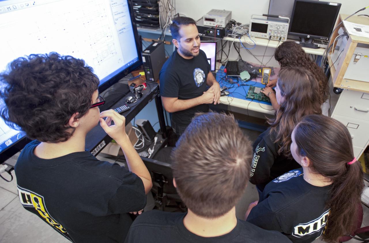 SAN LUIS OBISPO, Calif. – NASA mentors and the student launch team for the StangSat and Polysat go through final checks in the CubeSat lab facility at California Polytechnic Institute, or CalPoly. The payloads, which include sensors and equipment carefully packaged into 4-inch cubes, will ride in the body of a Garvey Spacecraft Corporation's Prospector P-18D rocket during a June 15 launch on a high-altitude, suborbital flight. Collectively known as CubeSats, the satellites will record shock, vibrations and heat inside the rocket. They will not be released during the test flight, but the results will be used to prove or strengthen their designs before they are carried into orbit in 2014 on a much larger rocket. A new, lightweight carrier is also being tested for use on future missions to deploy the small spacecraft. The flight also is being watched closely as a model for trying out new or off-the-shelf technologies quickly before putting them in the pipeline for use on NASA's largest launchers. Built by several different organizations, including a university, a NASA field center and a high school, the spacecraft are four-inch cubes designed to fly on their own eventually, but will remain firmly attached to the rocket during the upcoming mission. For more information, visit http://www.nasa.gov/mission_pages/smallsats/elana/cubesatlaunchpreview.html Photo credit: VAFB/Kathi Peoples