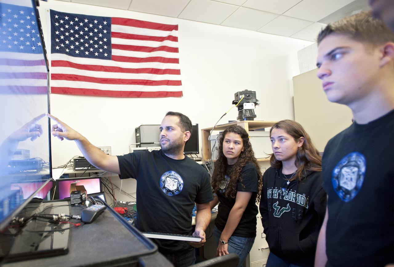 SAN LUIS OBISPO, Calif. – NASA mentors and the student launch team for the StangSat and Polysat go through final checks in the CubeSat lab facility at California Polytechnic Institute, or CalPoly. The payloads, which include sensors and equipment carefully packaged into 4-inch cubes, will ride in the body of a Garvey Spacecraft Corporation's Prospector P-18D rocket during a June 15 launch on a high-altitude, suborbital flight. Collectively known as CubeSats, the satellites will record shock, vibrations and heat inside the rocket. They will not be released during the test flight, but the results will be used to prove or strengthen their designs before they are carried into orbit in 2014 on a much larger rocket. A new, lightweight carrier is also being tested for use on future missions to deploy the small spacecraft. The flight also is being watched closely as a model for trying out new or off-the-shelf technologies quickly before putting them in the pipeline for use on NASA's largest launchers. Built by several different organizations, including a university, a NASA field center and a high school, the spacecraft are four-inch cubes designed to fly on their own eventually, but will remain firmly attached to the rocket during the upcoming mission. For more information, visit http://www.nasa.gov/mission_pages/smallsats/elana/cubesatlaunchpreview.html Photo credit: VAFB/Kathi Peoples