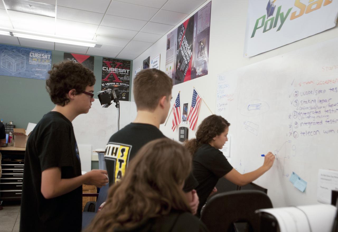 SAN LUIS OBISPO, Calif. – Members of the student launch team for the StangSat go through final checks in the CubeSat lab facility at California Polytechnic Institute, or CalPoly. The payloads, which include sensors and equipment carefully packaged into 4-inch cubes, will ride in the body of a Garvey Spacecraft Corporation's Prospector P-18D rocket during a June 15 launch on a high-altitude, suborbital flight. Collectively known as CubeSats, the satellites will record shock, vibrations and heat inside the rocket. They will not be released during the test flight, but the results will be used to prove or strengthen their designs before they are carried into orbit in 2014 on a much larger rocket. A new, lightweight carrier is also being tested for use on future missions to deploy the small spacecraft. The flight also is being watched closely as a model for trying out new or off-the-shelf technologies quickly before putting them in the pipeline for use on NASA's largest launchers. Built by several different organizations, including a university, a NASA field center and a high school, the spacecraft are four-inch cubes designed to fly on their own eventually, but will remain firmly attached to the rocket during the upcoming mission. For more information, visit http://www.nasa.gov/mission_pages/smallsats/elana/cubesatlaunchpreview.html Photo credit: VAFB/Kathi Peoples