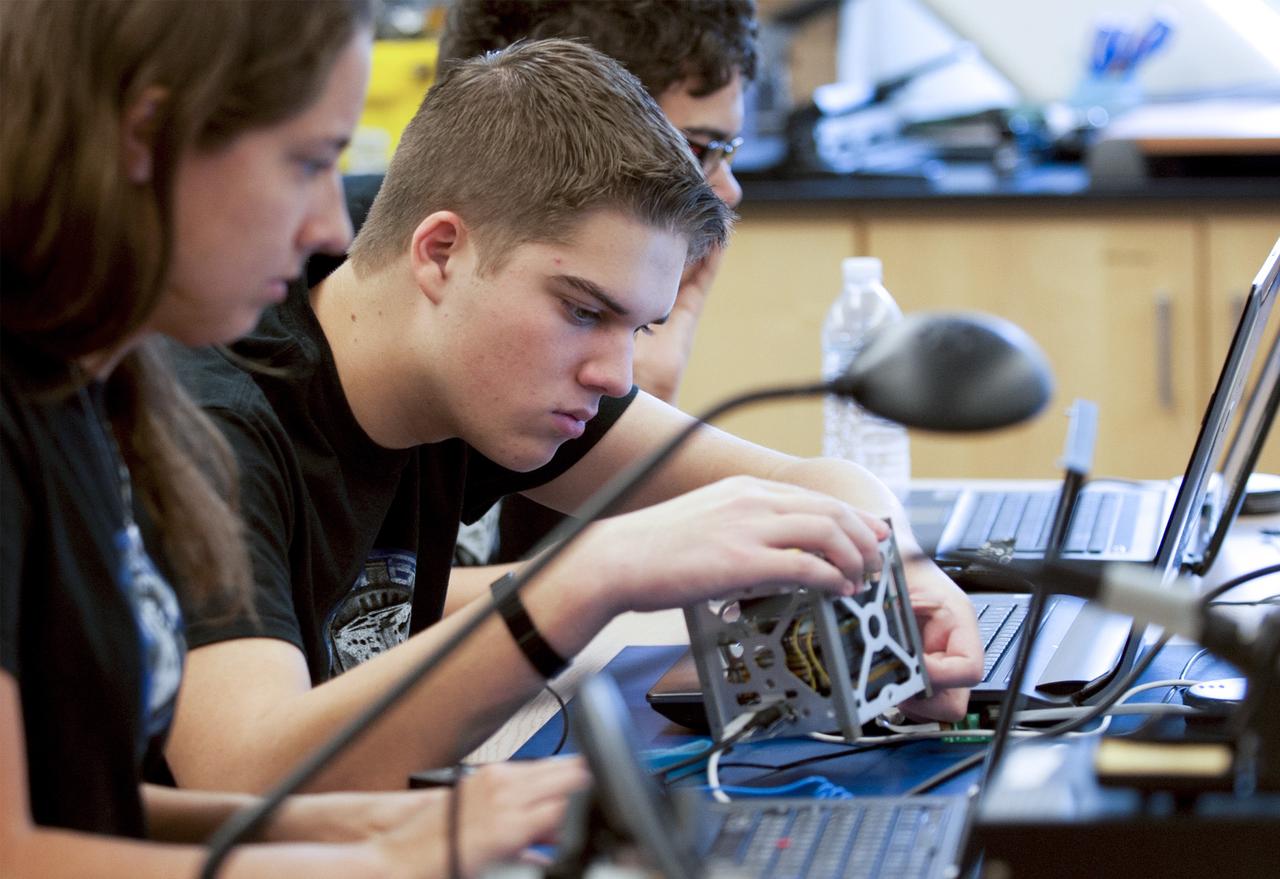 SAN LUIS OBISPO, Calif. – Members of the student launch team for the StangSat go through final checks in the CubeSat lab facility at California Polytechnic Institute, or CalPoly. The payloads, which include sensors and equipment carefully packaged into 4-inch cubes, will ride in the body of a Garvey Spacecraft Corporation's Prospector P-18D rocket during a June 15 launch on a high-altitude, suborbital flight. Collectively known as CubeSats, the satellites will record shock, vibrations and heat inside the rocket. They will not be released during the test flight, but the results will be used to prove or strengthen their designs before they are carried into orbit in 2014 on a much larger rocket. A new, lightweight carrier is also being tested for use on future missions to deploy the small spacecraft. The flight also is being watched closely as a model for trying out new or off-the-shelf technologies quickly before putting them in the pipeline for use on NASA's largest launchers. Built by several different organizations, including a university, a NASA field center and a high school, the spacecraft are four-inch cubes designed to fly on their own eventually, but will remain firmly attached to the rocket during the upcoming mission. For more information, visit http://www.nasa.gov/mission_pages/smallsats/elana/cubesatlaunchpreview.html Photo credit: VAFB/Kathi Peoples