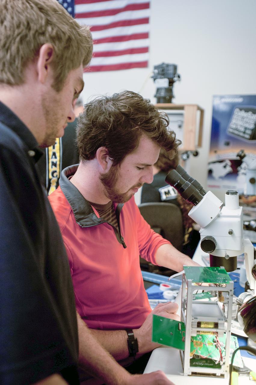 SAN LUIS OBISPO, Calif. – Members of the student launch team for the Polysat works through final checks in the CubeSat lab facility at California Polytechnic Institute, or CalPoly. The payload, which includes sensors and equipment carefully packaged into 4-inch cube sections, will ride in the body of a Garvey Spacecraft Corporation's Prospector P-18D rocket during a June 15 launch on a high-altitude, suborbital flight. Known as a CubeSat, the satellite will record shock, vibrations and heat inside the rocket. It will not be released during the test flight, but the results will be used to prove or strengthen their designs before they are carried into orbit in 2014 on a much larger rocket. A new, lightweight carrier is also being tested for use on future missions to deploy the small spacecraft. The flight also is being watched closely as a model for trying out new or off-the-shelf technologies quickly before putting them in the pipeline for use on NASA's largest launchers. Built by several different organizations, including a university, a NASA field center and a high school, the spacecraft are four-inch cubes designed to fly on their own eventually, but will remain firmly attached to the rocket during the upcoming mission. For more information, visit http://www.nasa.gov/mission_pages/smallsats/elana/cubesatlaunchpreview.html Photo credit: VAFB/Kathi Peoples