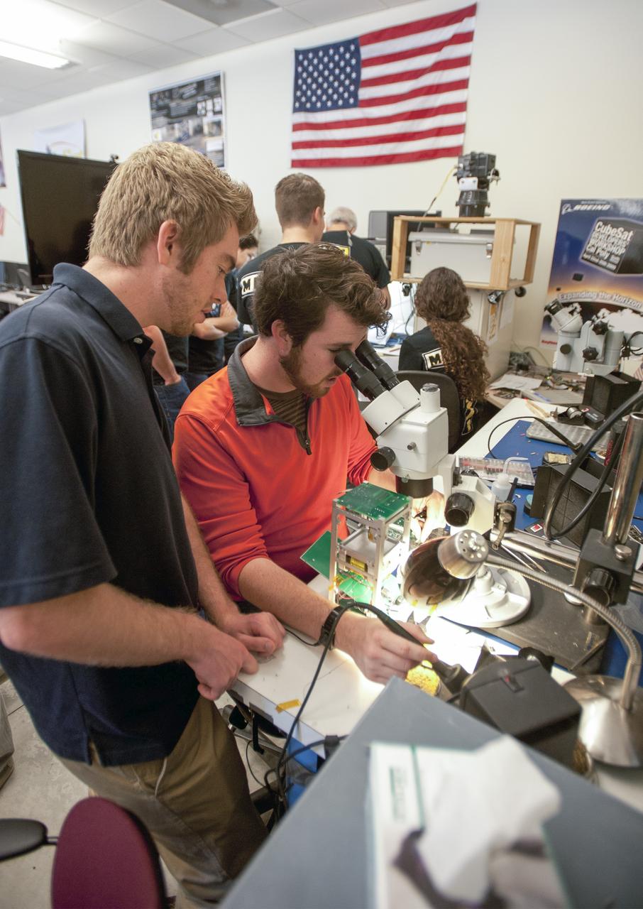 SAN LUIS OBISPO, Calif. – Members of the student launch team for the Polysat works through final checks in the CubeSat lab facility at California Polytechnic Institute, or CalPoly. The payload, which includes sensors and equipment carefully packaged into 4-inch cube sections, will ride in the body of a Garvey Spacecraft Corporation's Prospector P-18D rocket during a June 15 launch on a high-altitude, suborbital flight. Known as a CubeSat, the satellite will record shock, vibrations and heat inside the rocket. It will not be released during the test flight, but the results will be used to prove or strengthen their designs before they are carried into orbit in 2014 on a much larger rocket. A new, lightweight carrier is also being tested for use on future missions to deploy the small spacecraft. The flight also is being watched closely as a model for trying out new or off-the-shelf technologies quickly before putting them in the pipeline for use on NASA's largest launchers. Built by several different organizations, including a university, a NASA field center and a high school, the spacecraft are four-inch cubes designed to fly on their own eventually, but will remain firmly attached to the rocket during the upcoming mission. For more information, visit http://www.nasa.gov/mission_pages/smallsats/elana/cubesatlaunchpreview.html Photo credit: VAFB/Kathi Peoples