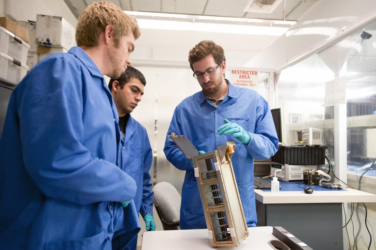 SAN LUIS OBISPO, Calif. –Members of the student launch team for the Polysat works through final checks in the CubeSat lab facility at California Polytechnic Institute, or CalPoly. The payload, which includes sensors and equipment carefully packaged into 4-inch cube sections, will ride in the body of a Garvey Spacecraft Corporation's Prospector P-18D rocket during a June 15 launch on a high-altitude, suborbital flight. Known as a CubeSat, the satellite will record shock, vibrations and heat inside the rocket. It will not be released during the test flight, but the results will be used to prove or strengthen their designs before they are carried into orbit in 2014 on a much larger rocket. A new, lightweight carrier is also being tested for use on future missions to deploy the small spacecraft. The flight also is being watched closely as a model for trying out new or off-the-shelf technologies quickly before putting them in the pipeline for use on NASA's largest launchers. Built by several different organizations, including a university, a NASA field center and a high school, the spacecraft are four-inch cubes designed to fly on their own eventually, but will remain firmly attached to the rocket during the upcoming mission. For more information, visit http://www.nasa.gov/mission_pages/smallsats/elana/cubesatlaunchpreview.html Photo credit: VAFB/Kathi Peoples