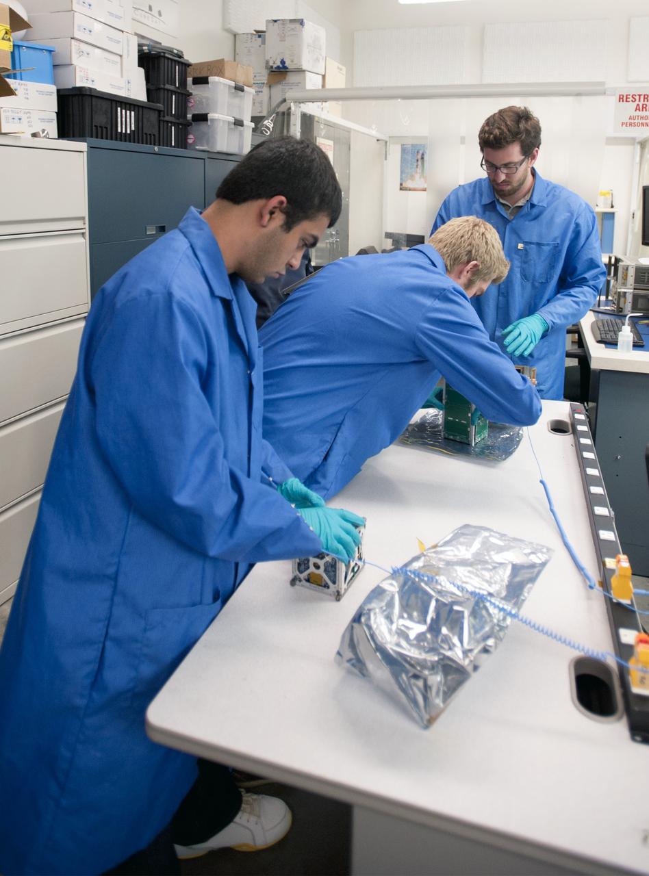 SAN LUIS OBISPO, Calif. –Members of the student launch team for the Polysat works through final checks in the CubeSat lab facility at California Polytechnic Institute, or CalPoly. The payload, which includes sensors and equipment carefully packaged into 4-inch cube sections, will ride in the body of a Garvey Spacecraft Corporation's Prospector P-18D rocket during a June 15 launch on a high-altitude, suborbital flight. Known as a CubeSat, the satellite will record shock, vibrations and heat inside the rocket. It will not be released during the test flight, but the results will be used to prove or strengthen their designs before they are carried into orbit in 2014 on a much larger rocket. A new, lightweight carrier is also being tested for use on future missions to deploy the small spacecraft. The flight also is being watched closely as a model for trying out new or off-the-shelf technologies quickly before putting them in the pipeline for use on NASA's largest launchers. Built by several different organizations, including a university, a NASA field center and a high school, the spacecraft are four-inch cubes designed to fly on their own eventually, but will remain firmly attached to the rocket during the upcoming mission. For more information, visit http://www.nasa.gov/mission_pages/smallsats/elana/cubesatlaunchpreview.html Photo credit: VAFB/Kathi Peoples