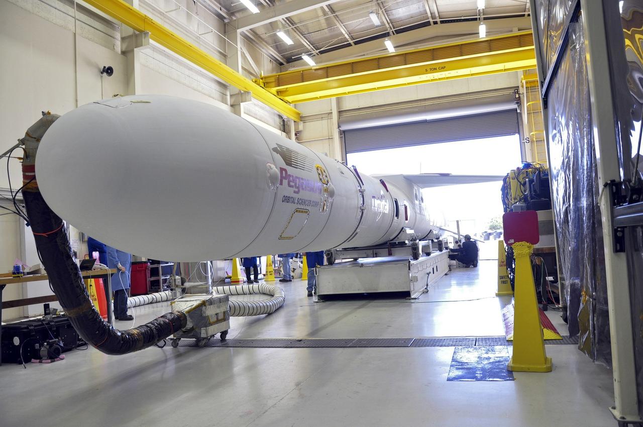 VANDENBERG ABF, Calif. - The Orbital Sciences Pegasus XL rocket that will lift NASA's IRIS solar observatory into orbit is moved from a hangar onto a transporter at Vandenberg Air Force Base. IRIS, short for Interface Region Imaging Spectrograph, is being prepared for launch from Vandenberg June 26. IRIS will open a new window of discovery by tracing the flow of energy and plasma through the chromospheres and transition region into the sun’s corona using spectrometry and imaging. IRIS fills a crucial gap in our ability to advance studies of the sun-to-Earth connection by tracing the flow of energy and plasma through the foundation of the corona and the region around the sun known as the heliosphere. Photo credit: VAFB/Randy Beaudoin