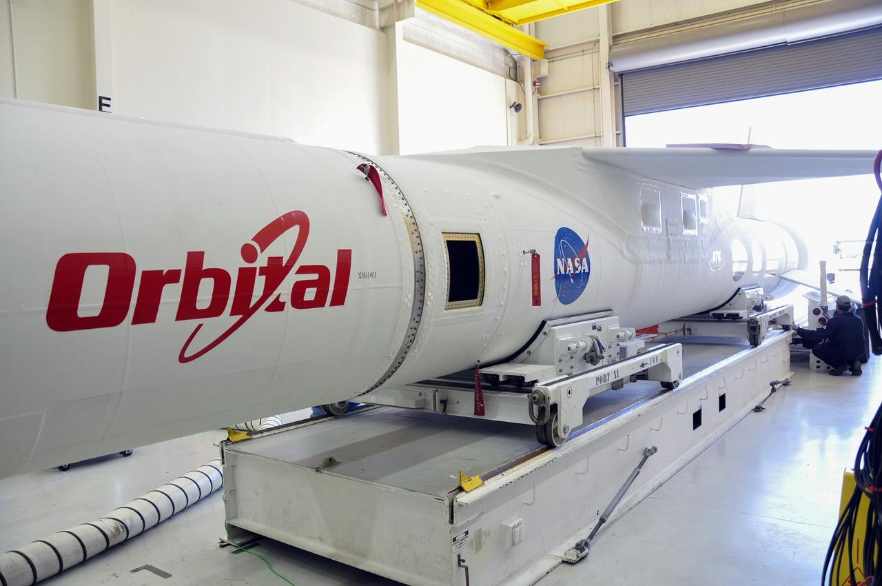 VANDENBERG ABF, Calif. - The Orbital Sciences Pegasus XL rocket that will lift NASA's IRIS solar observatory into orbit is moved from a hangar onto a transporter at Vandenberg Air Force Base. IRIS, short for Interface Region Imaging Spectrograph, is being prepared for launch from Vandenberg June 26. IRIS will open a new window of discovery by tracing the flow of energy and plasma through the chromospheres and transition region into the sun’s corona using spectrometry and imaging. IRIS fills a crucial gap in our ability to advance studies of the sun-to-Earth connection by tracing the flow of energy and plasma through the foundation of the corona and the region around the sun known as the heliosphere. Photo credit: VAFB/Randy Beaudoin