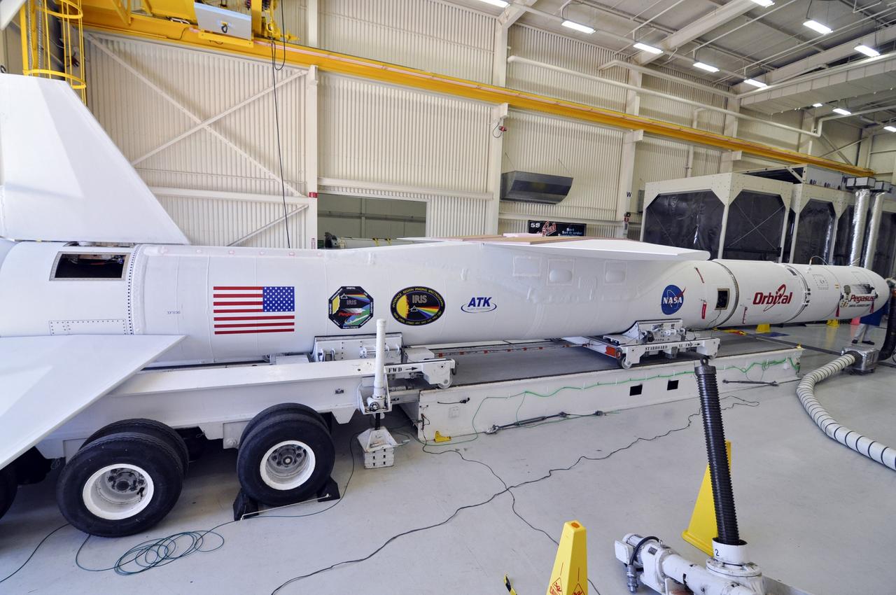 VANDENBERG ABF, Calif. - The Orbital Sciences Pegasus XL rocket that will lift NASA's IRIS solar observatory into orbit is moved from a hangar onto a transporter at Vandenberg Air Force Base. IRIS, short for Interface Region Imaging Spectrograph, is being prepared for launch from Vandenberg June 26. IRIS will open a new window of discovery by tracing the flow of energy and plasma through the chromospheres and transition region into the sun’s corona using spectrometry and imaging. IRIS fills a crucial gap in our ability to advance studies of the sun-to-Earth connection by tracing the flow of energy and plasma through the foundation of the corona and the region around the sun known as the heliosphere. Photo credit: VAFB/Randy Beaudoin