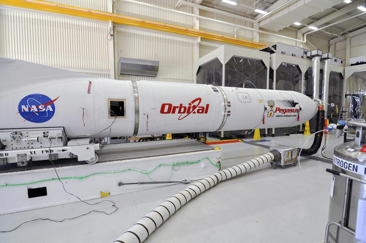 VANDENBERG ABF, Calif. - The Orbital Sciences Pegasus XL rocket that will lift NASA's IRIS solar observatory into orbit is moved from a hangar onto a transporter at Vandenberg Air Force Base. IRIS, short for Interface Region Imaging Spectrograph, is being prepared for launch from Vandenberg June 26. IRIS will open a new window of discovery by tracing the flow of energy and plasma through the chromospheres and transition region into the sun’s corona using spectrometry and imaging. IRIS fills a crucial gap in our ability to advance studies of the sun-to-Earth connection by tracing the flow of energy and plasma through the foundation of the corona and the region around the sun known as the heliosphere. Photo credit: VAFB/Randy Beaudoin
