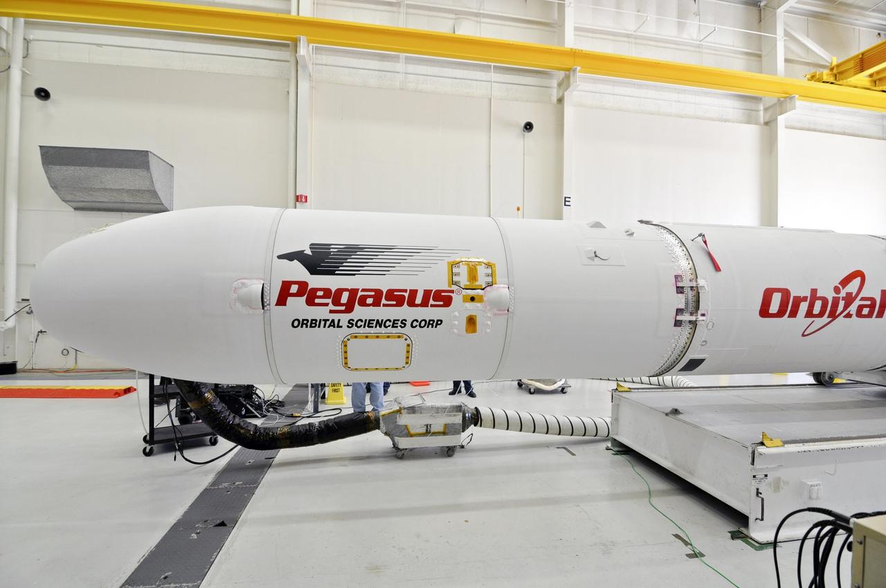 VANDENBERG ABF, Calif. - The Orbital Sciences Pegasus XL rocket that will lift NASA's IRIS solar observatory into orbit is moved from a hangar onto a transporter at Vandenberg Air Force Base. IRIS, short for Interface Region Imaging Spectrograph, is being prepared for launch from Vandenberg June 26. IRIS will open a new window of discovery by tracing the flow of energy and plasma through the chromospheres and transition region into the sun’s corona using spectrometry and imaging. IRIS fills a crucial gap in our ability to advance studies of the sun-to-Earth connection by tracing the flow of energy and plasma through the foundation of the corona and the region around the sun known as the heliosphere. Photo credit: VAFB/Randy Beaudoin