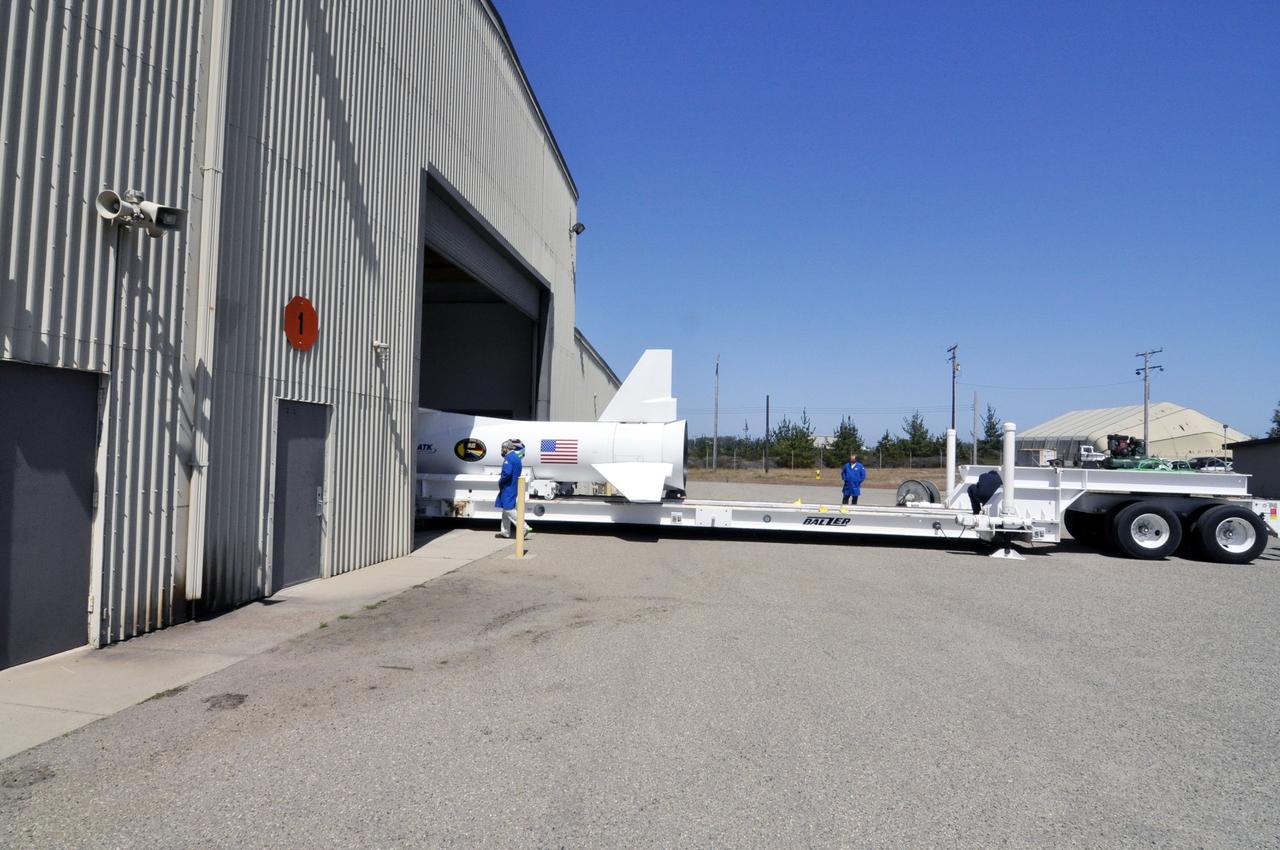 VANDENBERG ABF, Calif. - The Orbital Sciences Pegasus XL rocket that will lift NASA's IRIS solar observatory into orbit is moved from a hangar onto a transporter at Vandenberg Air Force Base. IRIS, short for Interface Region Imaging Spectrograph, is being prepared for launch from Vandenberg June 26. IRIS will open a new window of discovery by tracing the flow of energy and plasma through the chromospheres and transition region into the sun’s corona using spectrometry and imaging. IRIS fills a crucial gap in our ability to advance studies of the sun-to-Earth connection by tracing the flow of energy and plasma through the foundation of the corona and the region around the sun known as the heliosphere. Photo credit: VAFB/Randy Beaudoin