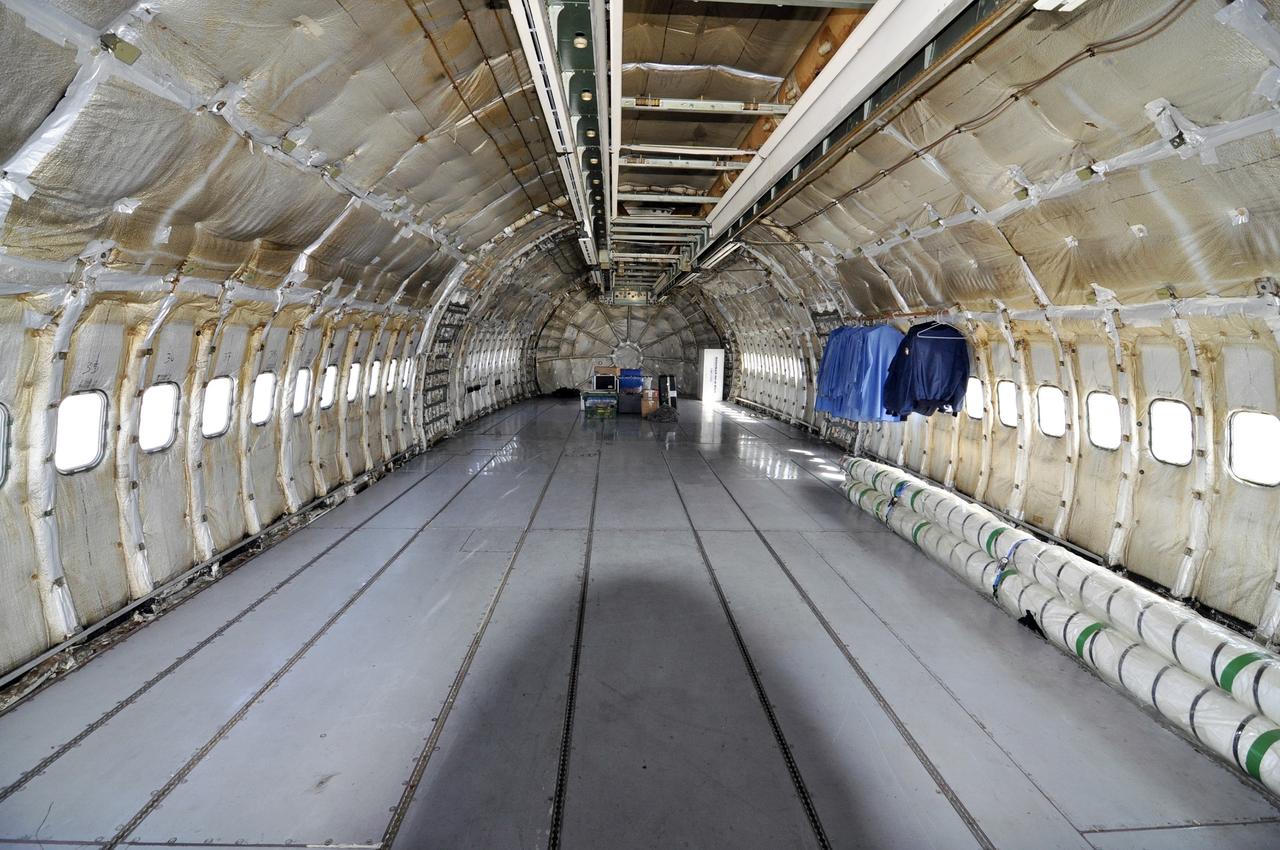 VANDENBERG ABF, Calif. – A look through the inside of the fuselage of the Orbital Sciences L-1011 aircraft called "Stargazer" after arrival at Vandenberg Air Force Base for the upcoming launch of the company's Pegasus XL rocket lifting NASA's IRIS solar observatory into orbit. The aircraft will carry the winged rocket to an altitude of 39,000 feet before releasing the Pegasus so its own motors can ignite to send the IRIS into space. The L-1011 is a modified airliner equipped to hold the Pegasus under its body safely. IRIS, short for Interface Region Imaging Spectrograph, is being prepared for launch from Vandenberg June 26. IRIS will open a new window of discovery by tracing the flow of energy and plasma through the chromospheres and transition region into the sun’s corona using spectrometry and imaging. IRIS fills a crucial gap in our ability to advance studies of the sun-to-Earth connection by tracing the flow of energy and plasma through the foundation of the corona and the region around the sun known as the heliosphere. Photo credit: VAFB/Randy Beaudoin