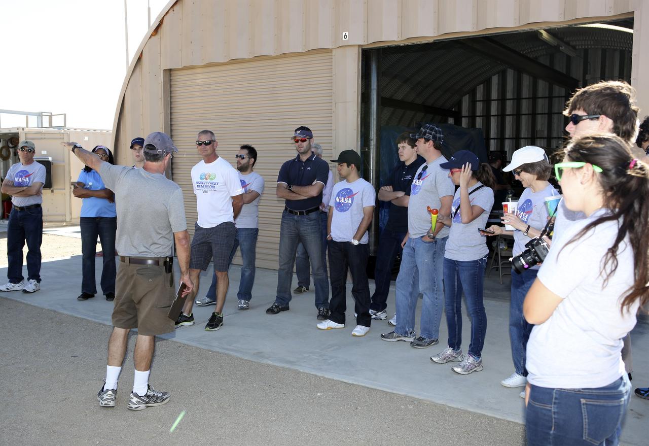 MOJAVE DESERT, Calif. – In the Mojave Desert in California, students and engineers participate in a pre-task briefing as preparations continue for the June 15 launch of a Garvey Spacecraft Corporation Prospector P-18D rocket on a high-altitude, suborbital flight. The rocket will carry four satellites made from four-inch cube section. Collectively known as CubeSats, the satellites will record shock, vibrations and heat inside the rocket. They will not be released during the test flight, but the results will be used to prove or strengthen their designs before they are carried into orbit in 2014 on a much larger rocket. A new, lightweight carrier is also being tested for use on future missions to deploy the small spacecraft. The flight also is being watched closely as a model for trying out new or off-the-shelf technologies quickly before putting them in the pipeline for use on NASA's largest launchers. Built by several different organizations, including a university, a NASA field center and a high school, the spacecraft are four-inch cubes designed to fly on their own eventually, but will remain firmly attached to the rocket during the upcoming mission. For more information, visit http://www.nasa.gov/mission_pages/smallsats/elana/cubesatlaunchpreview.html Photo credit: NASA/Dimitri Gerondidakis